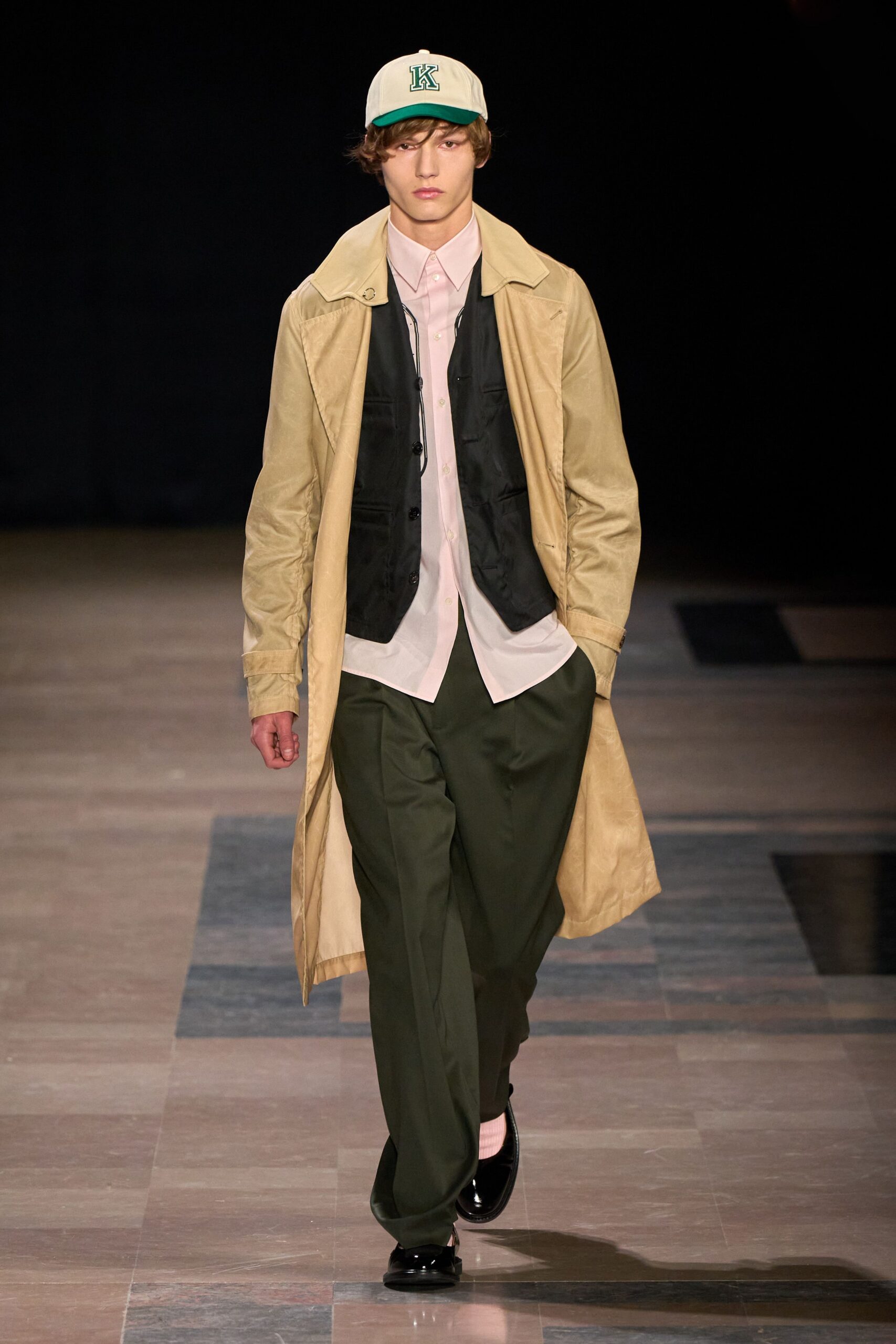 beige coat black vest white shirt green pants
