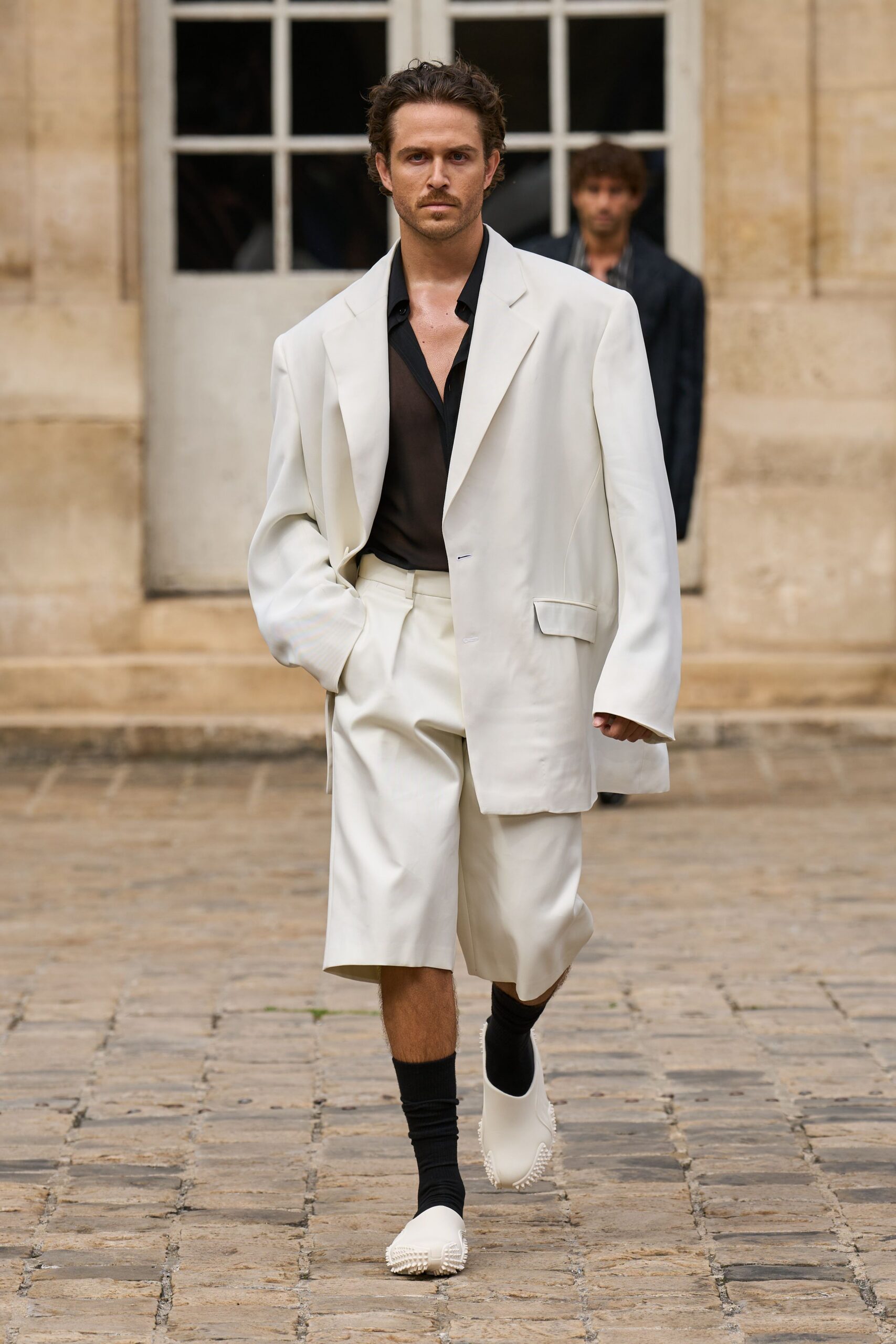 white blazer black shirt relaxed shorts