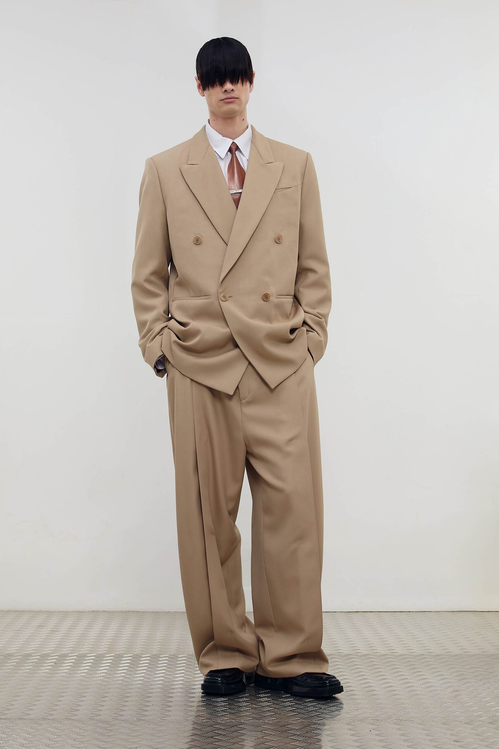 beige relaxed suit with black shoes