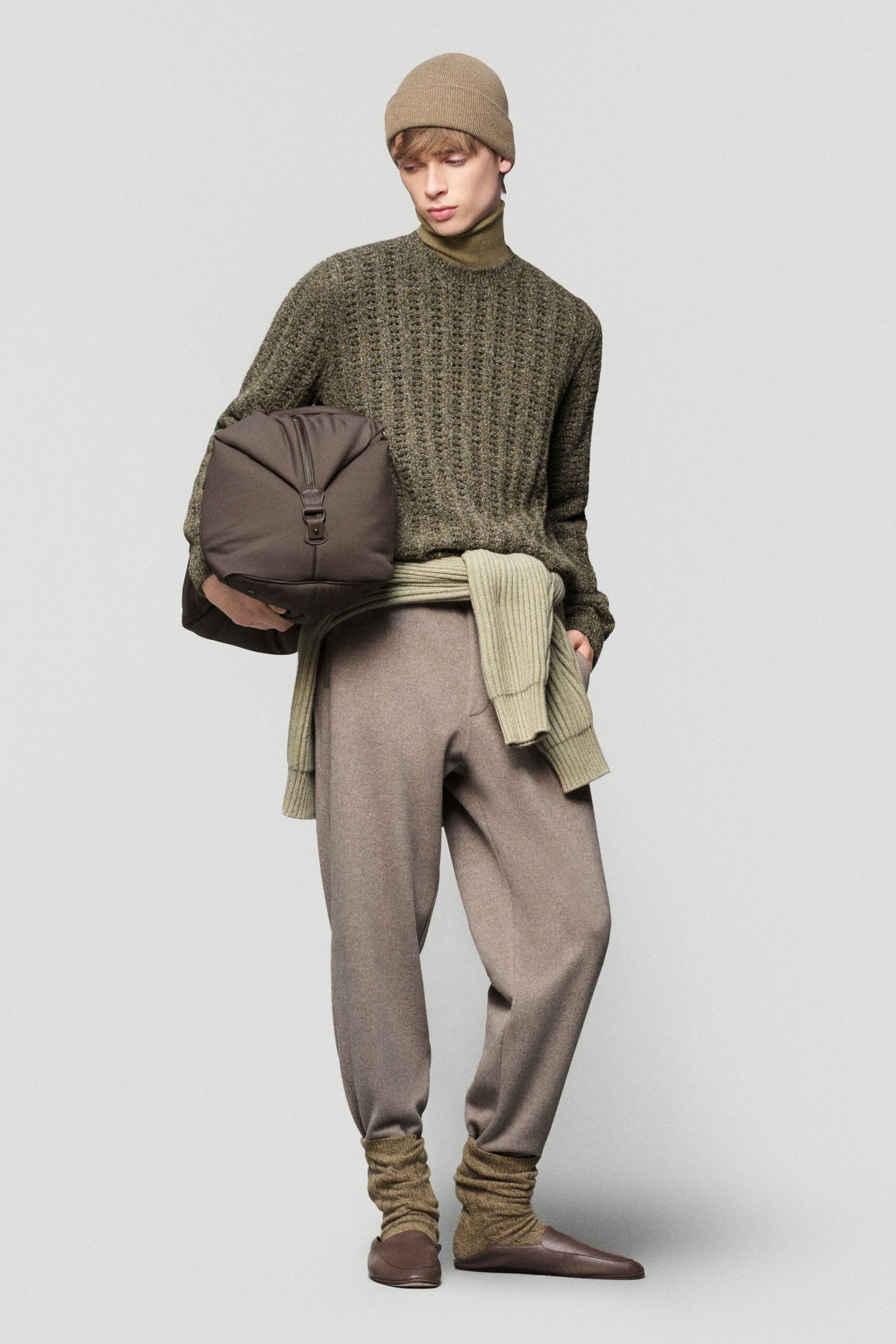 green wool sweater with beige pants
