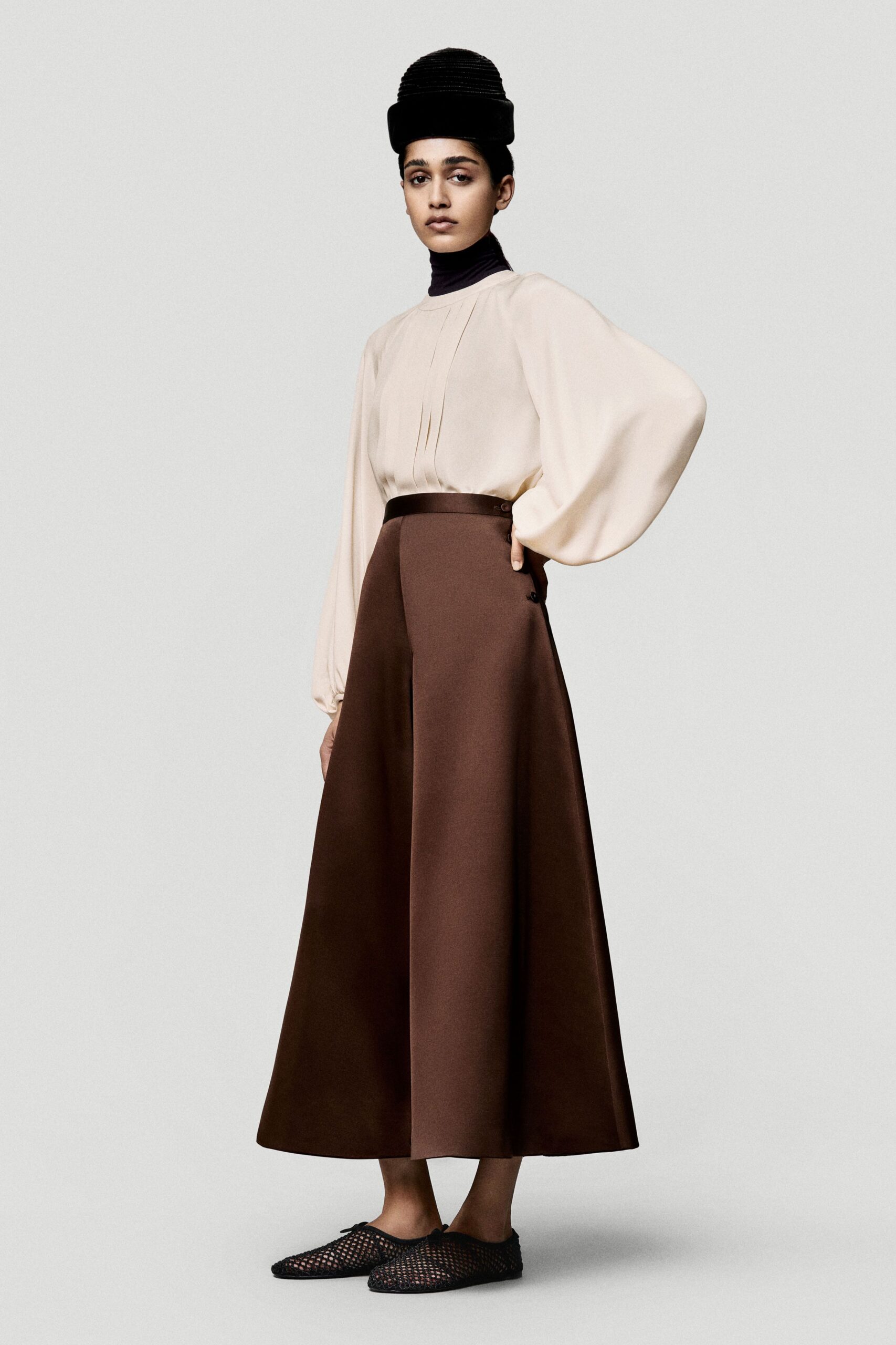 beige silk long-sleeve high-neck relaxed pleated blouse