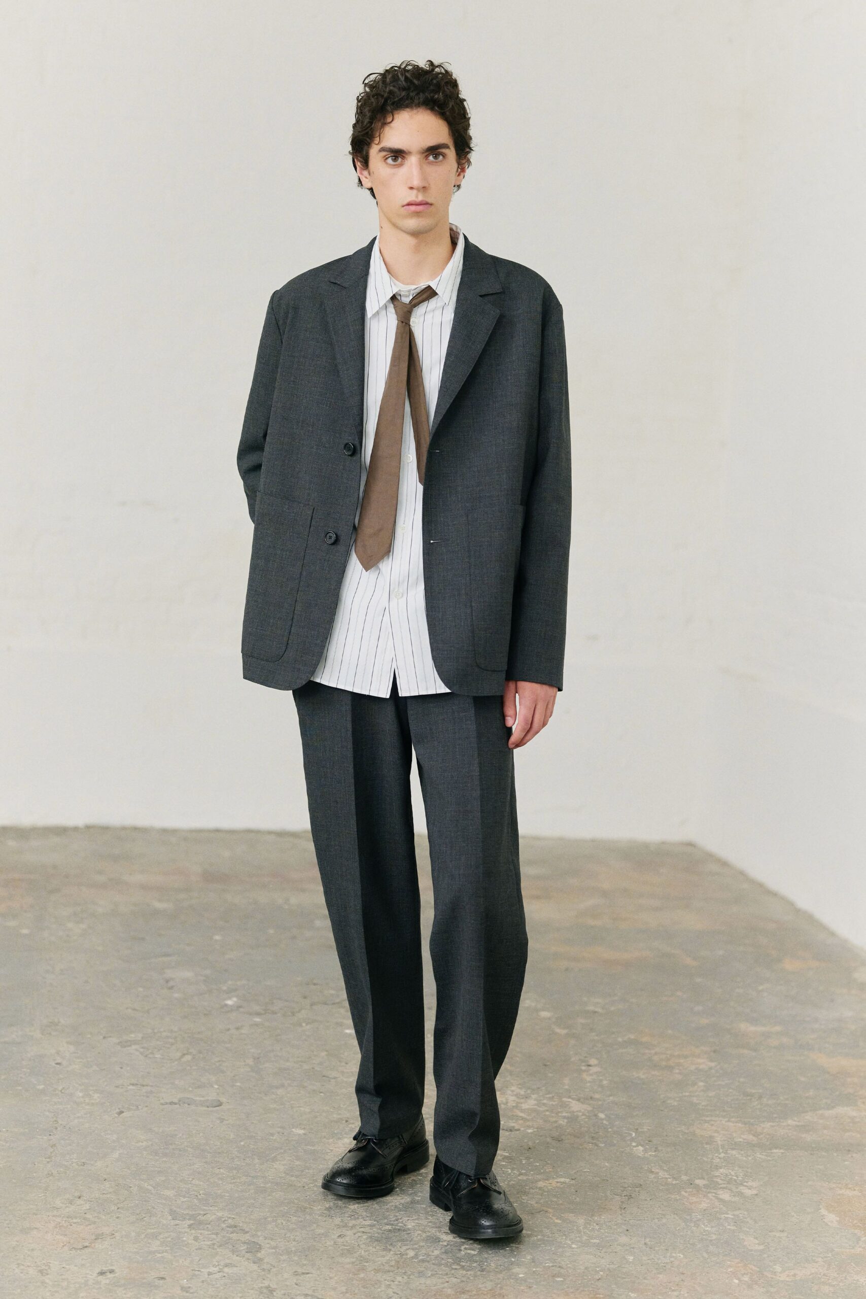 gray tailored suit with striped shirt