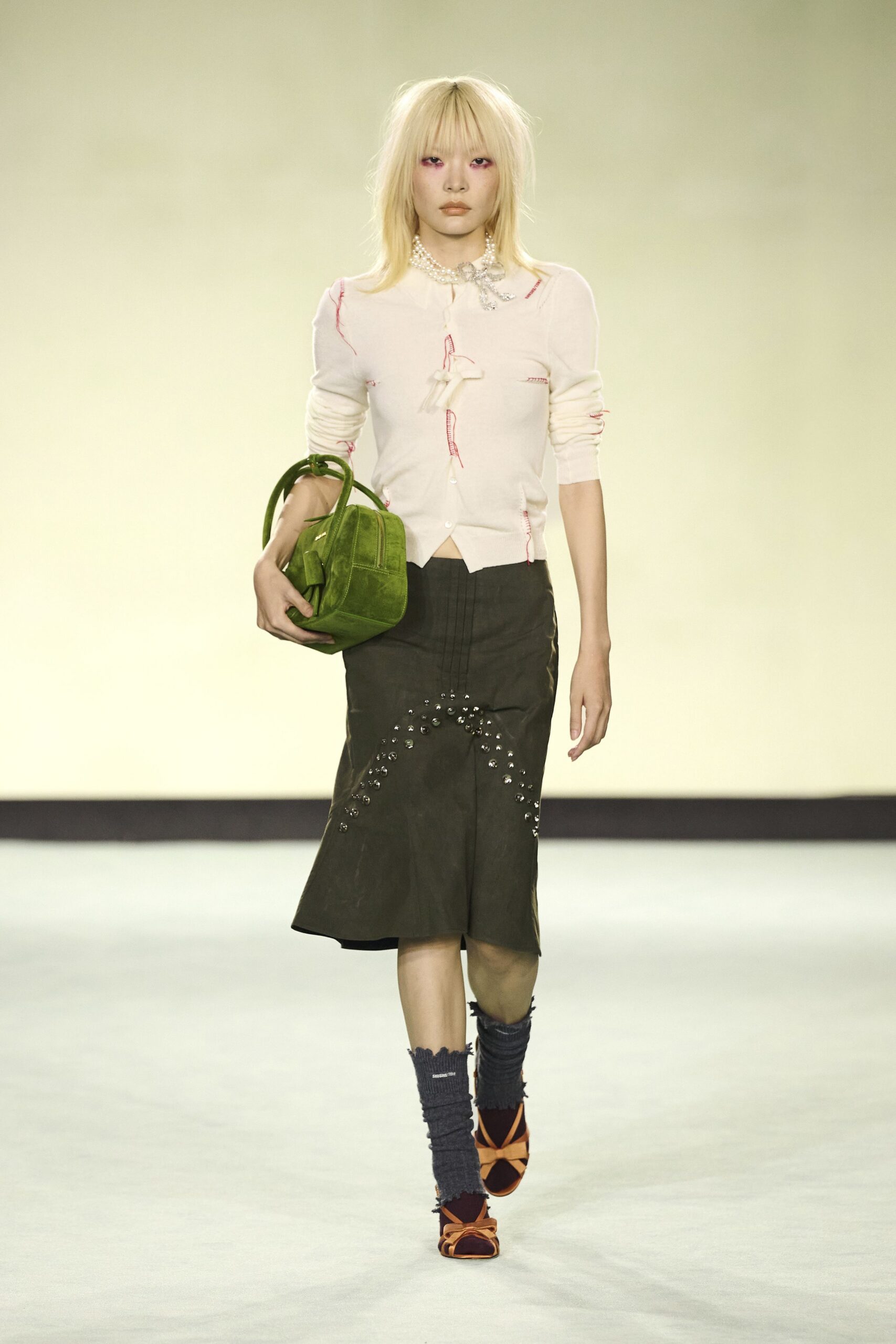 white fitted top green skirt