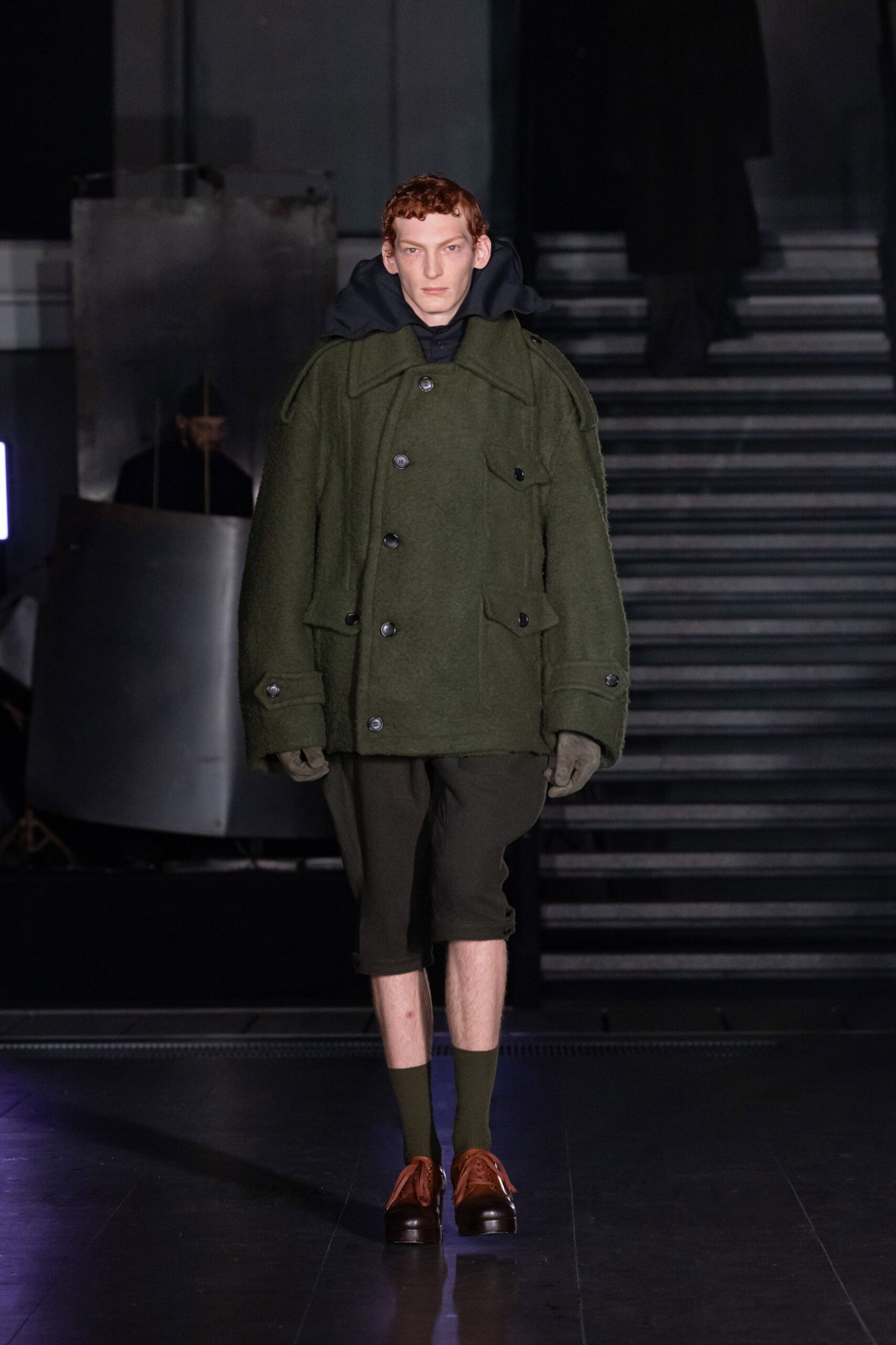 green oversized coat with black shorts