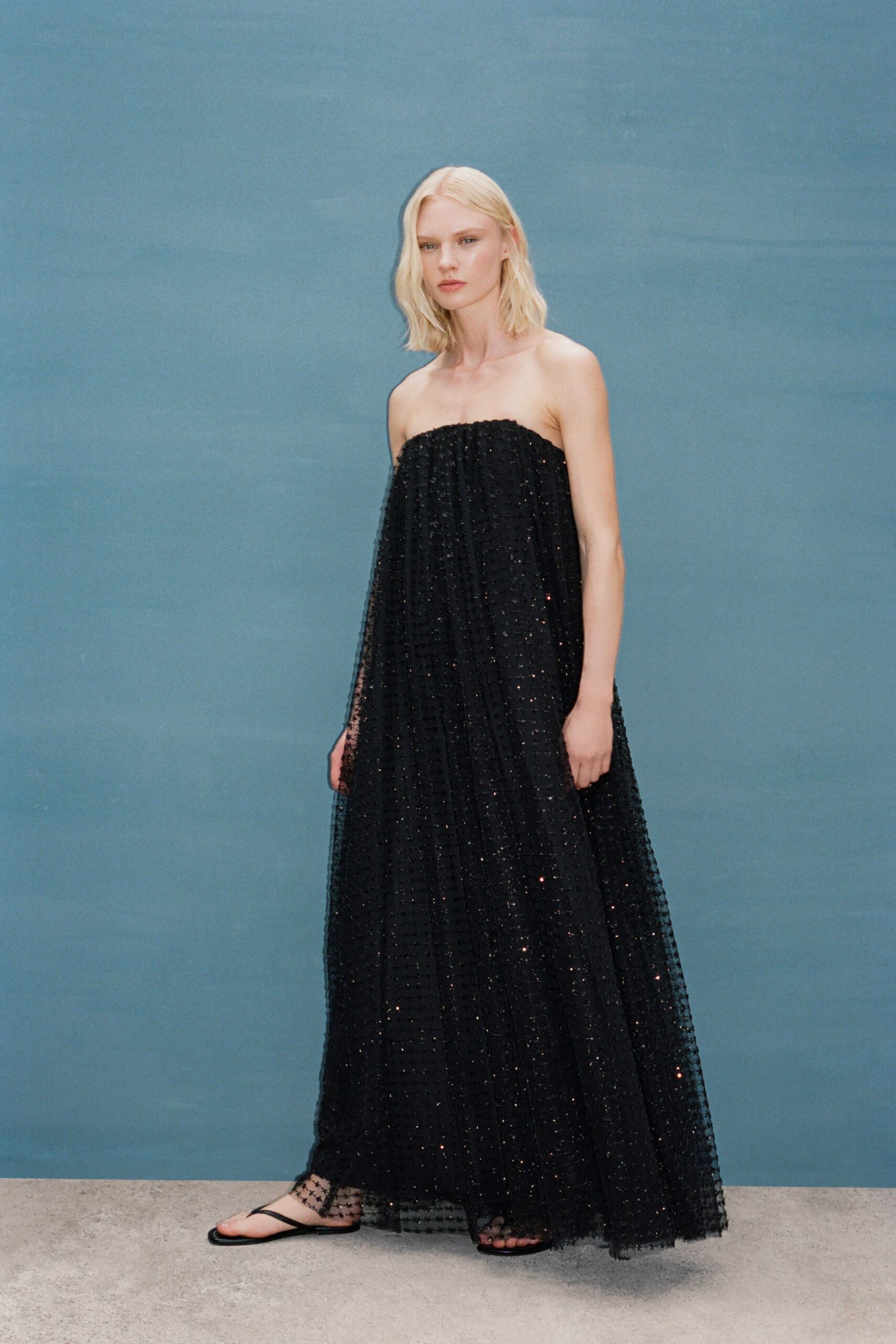 black tulle strapless fitted pleated layered flowing gown