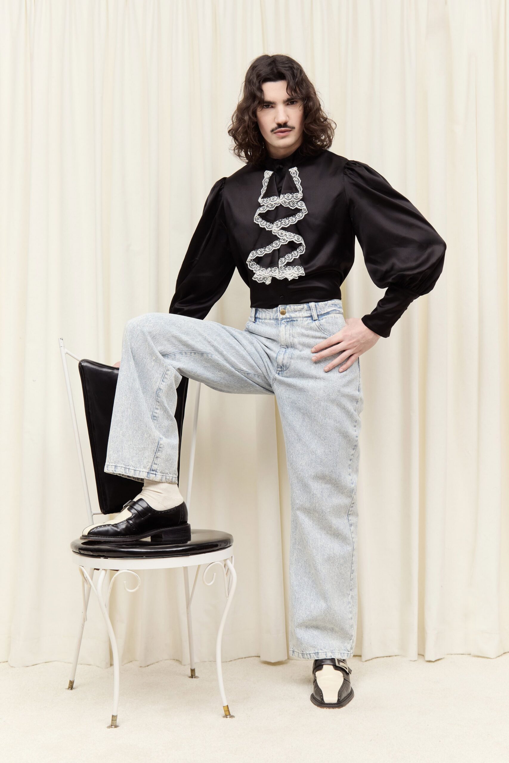 black silk ruffled shirt and denim pants