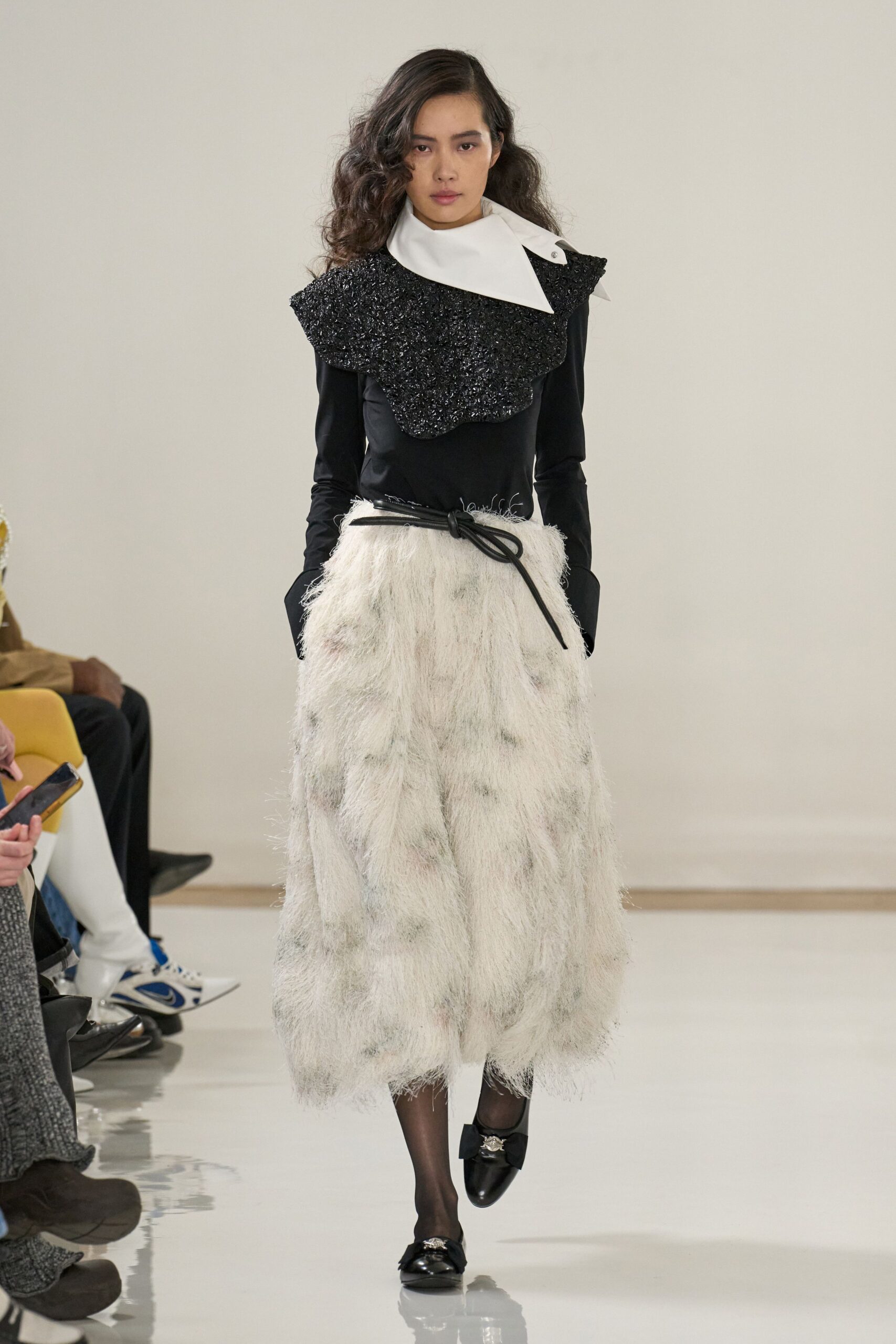 black fitted top with white skirt
