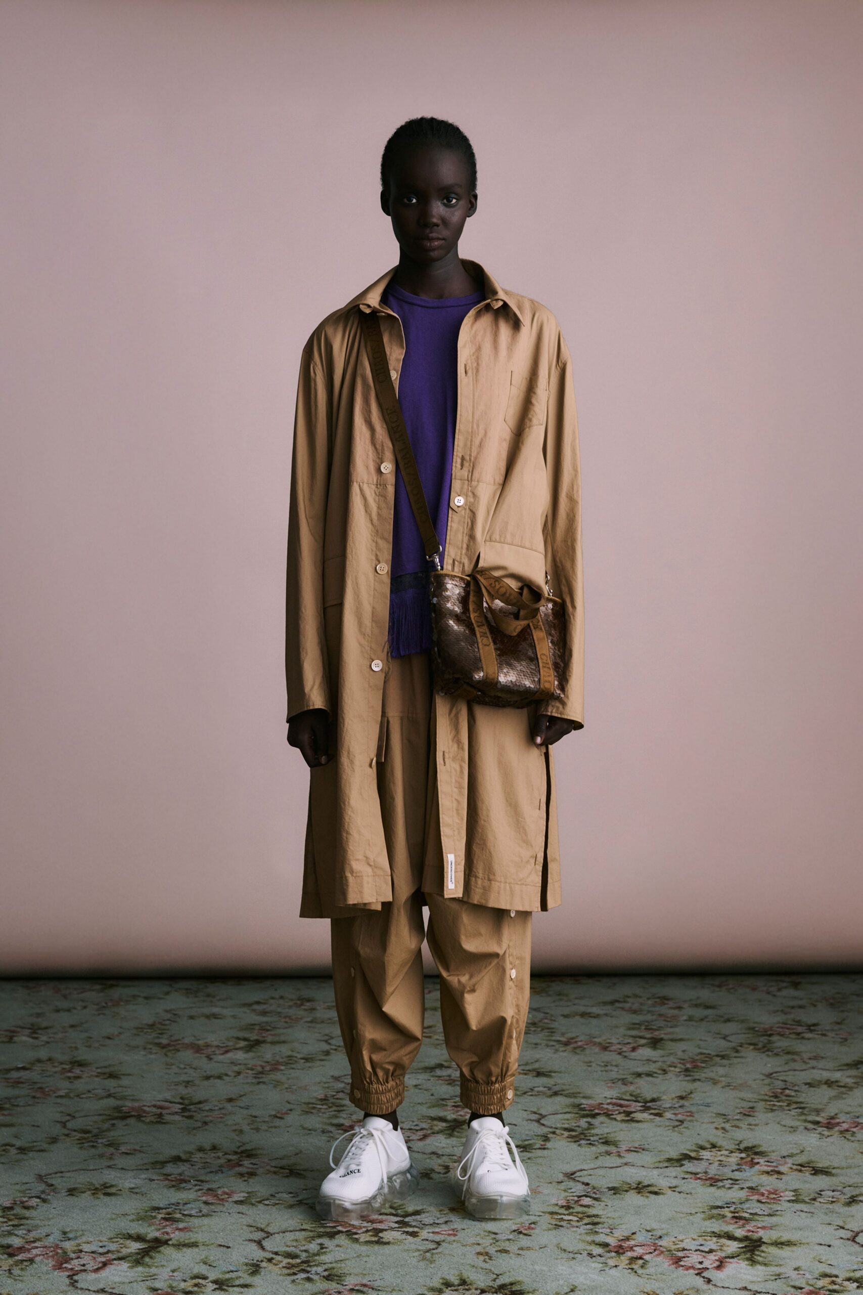 beige coat purple top beige pants