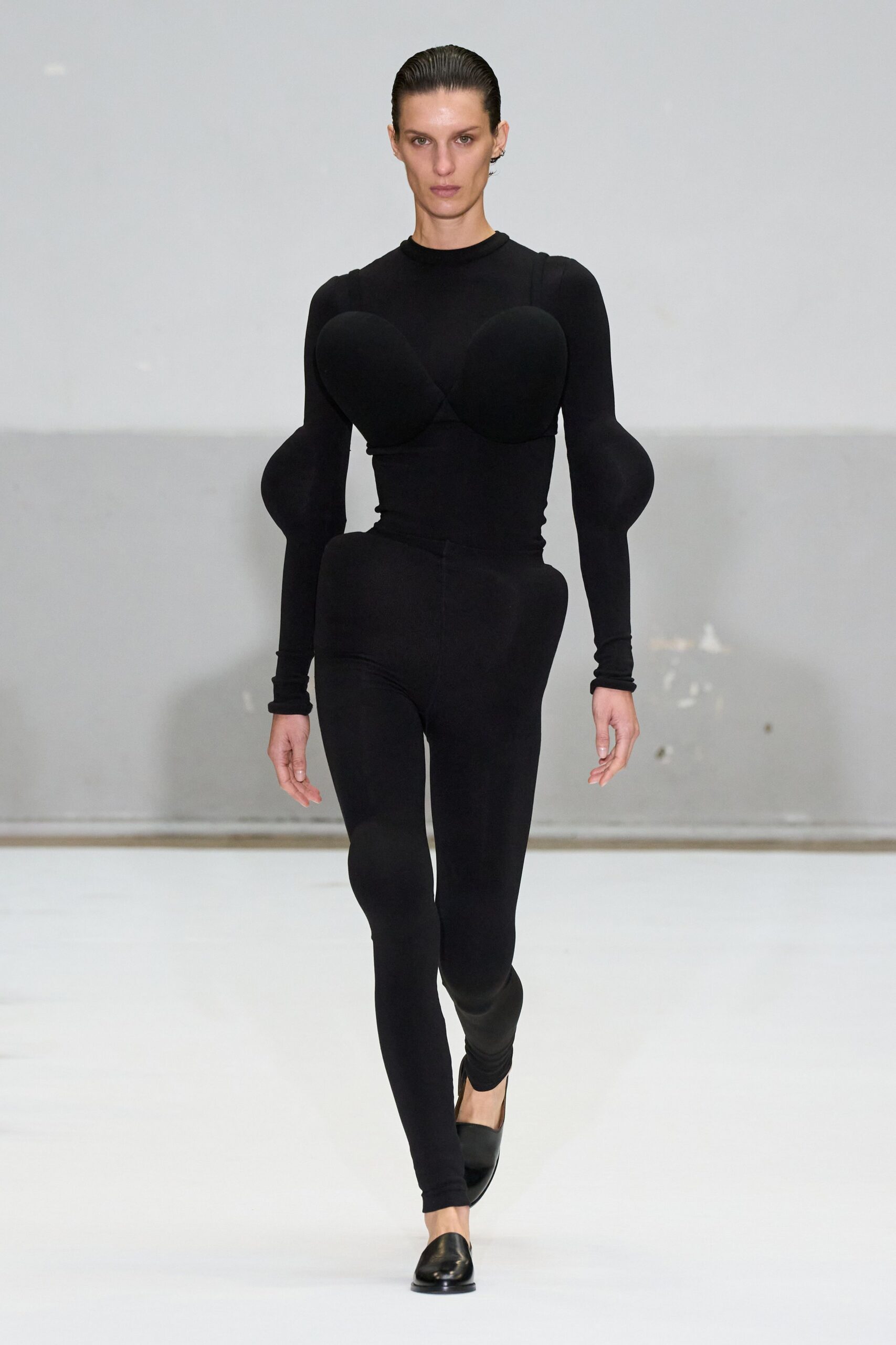 black fitted catsuit with padded details