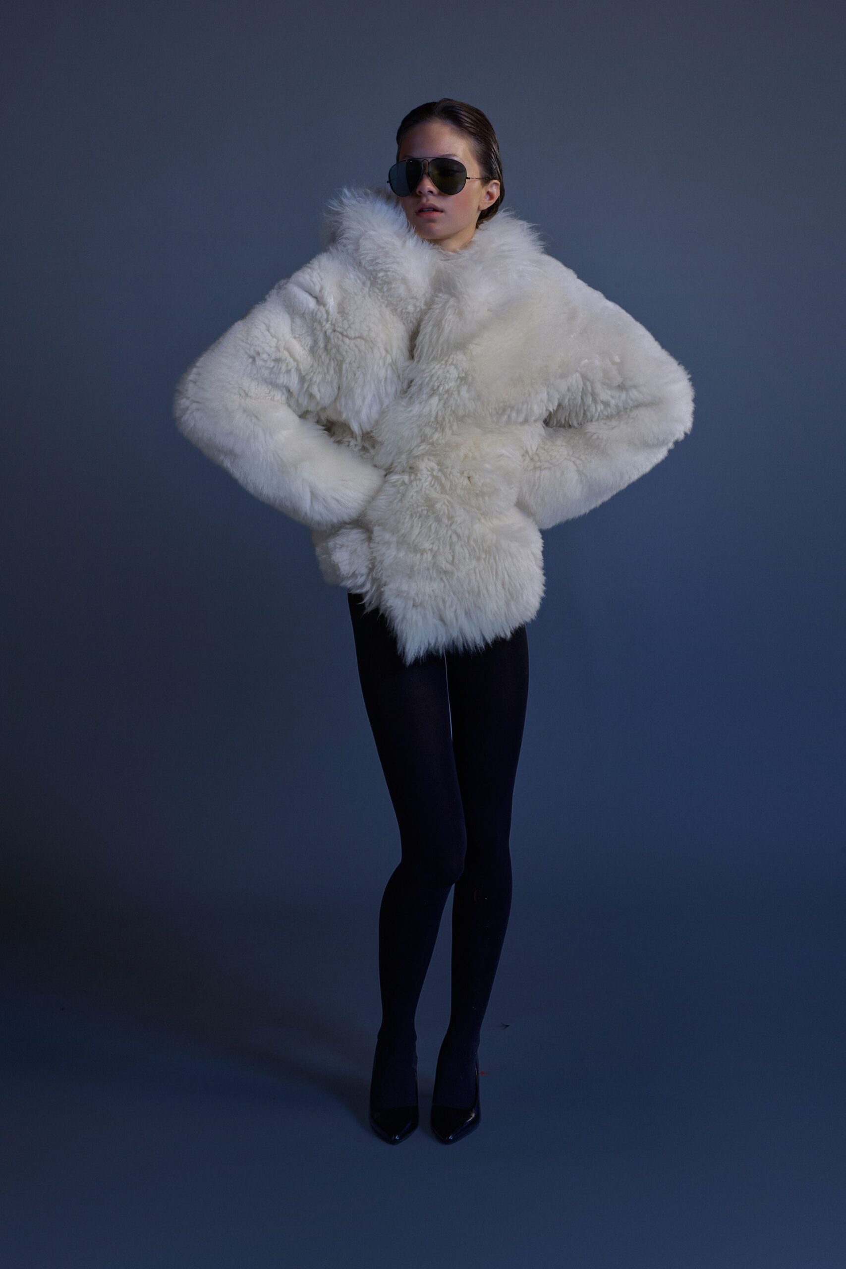 white fur coat with black leggings