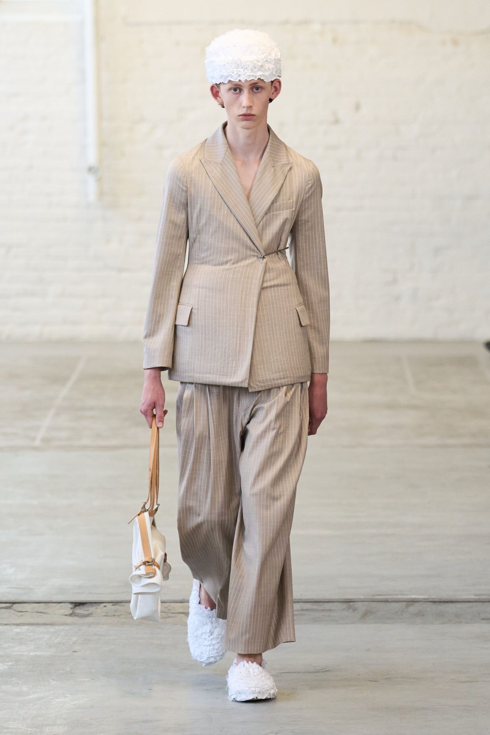 beige tailored suit with white accessories
