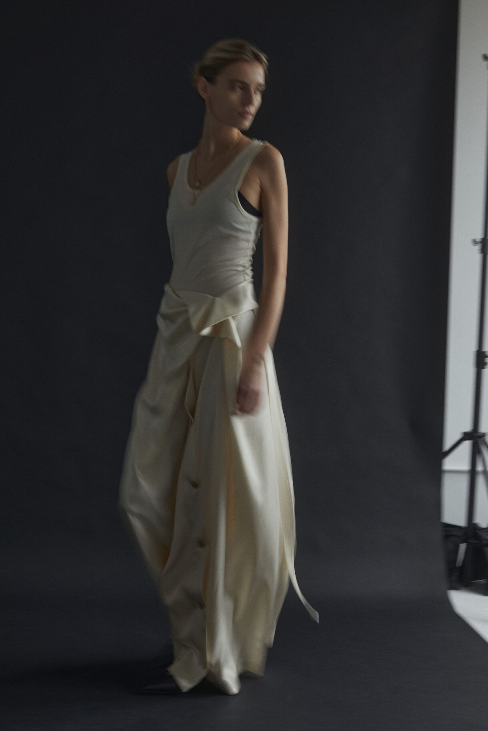beige silk sleeveless top and relaxed pants