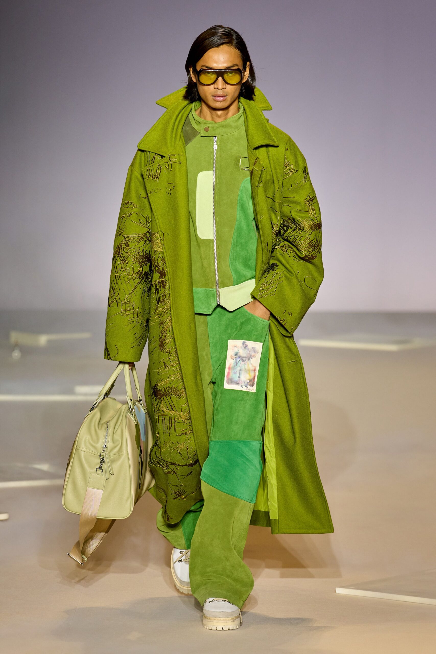 green oversized coat with sunglasses