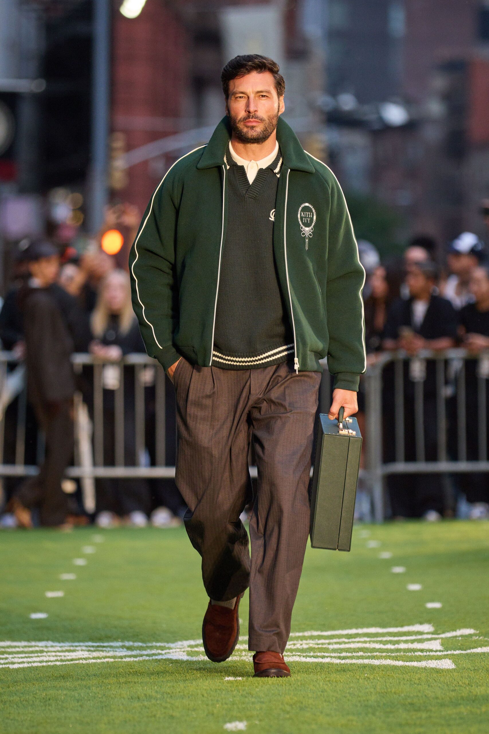 green jacket black sweater gray pants