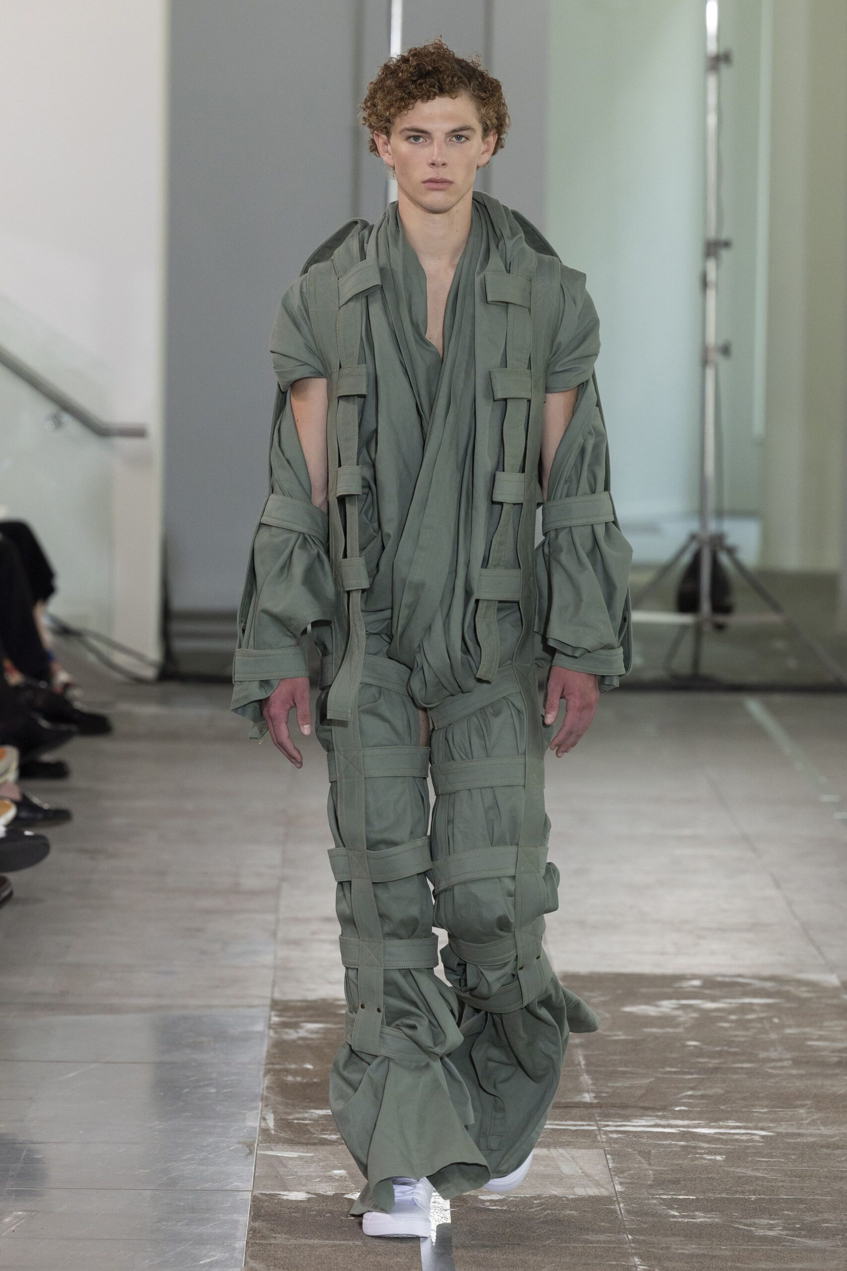 green relaxed jumpsuit with white shoes