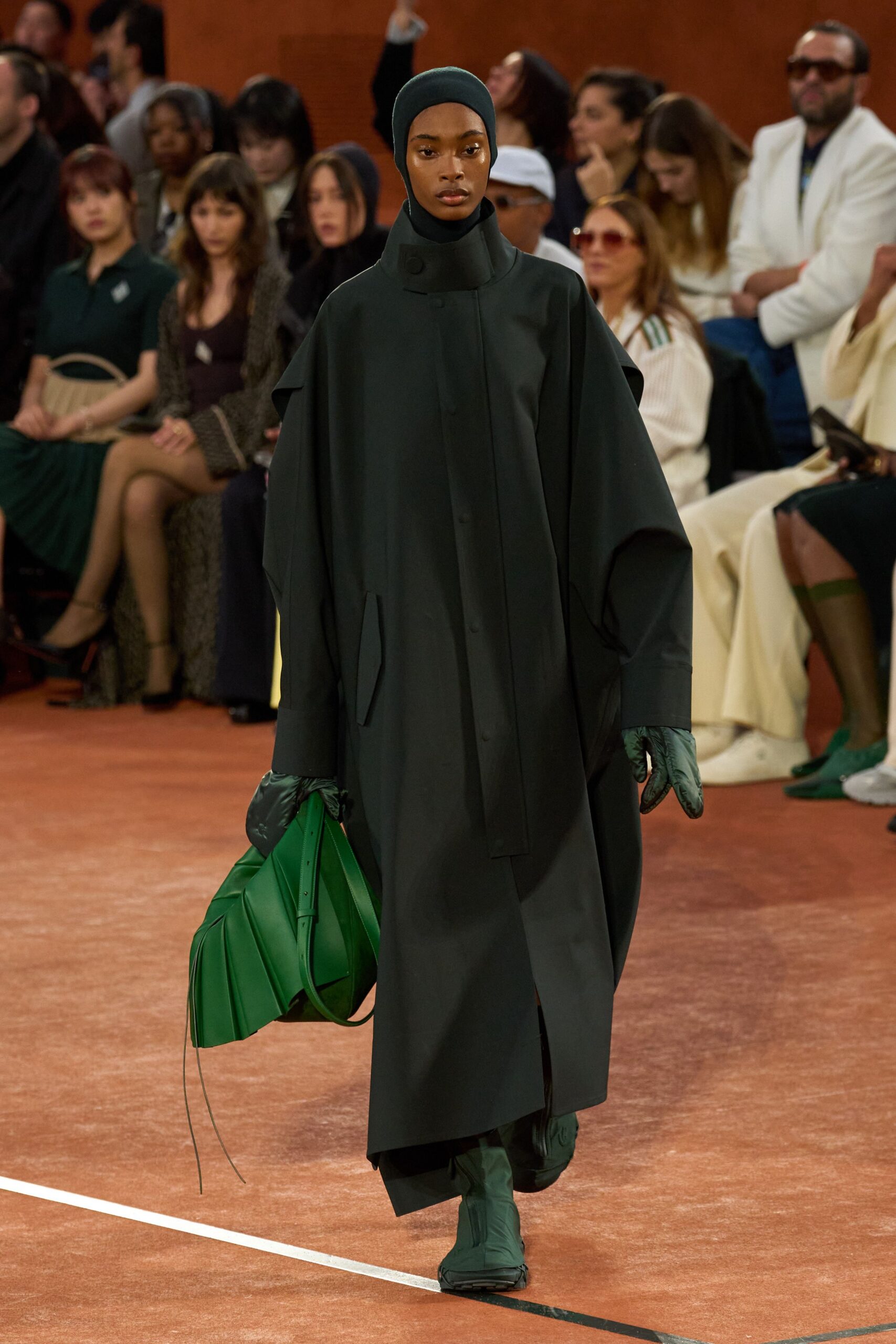 oversized black coat with green accessories