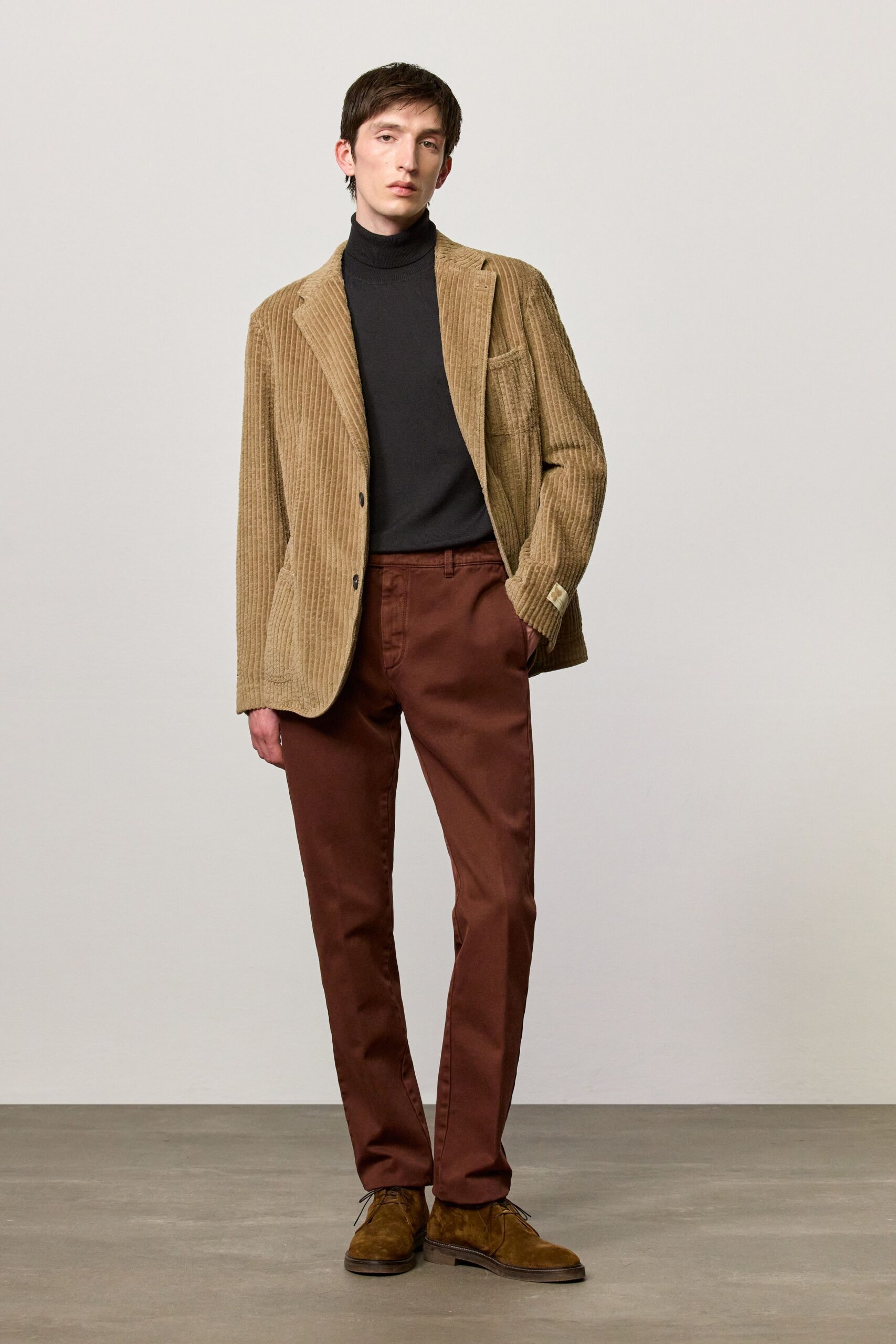 beige blazer black turtleneck brown pants