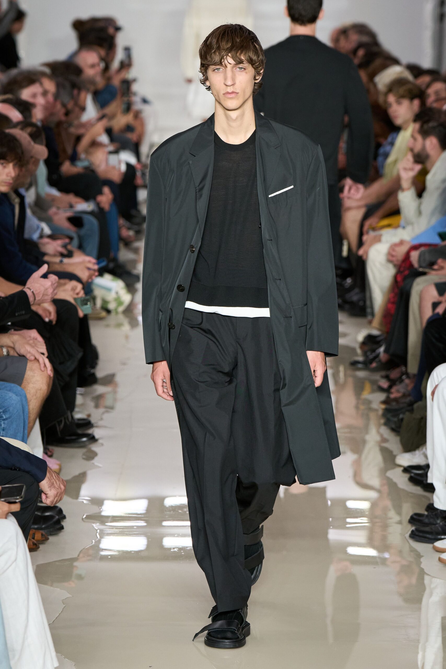 black coat and relaxed pants