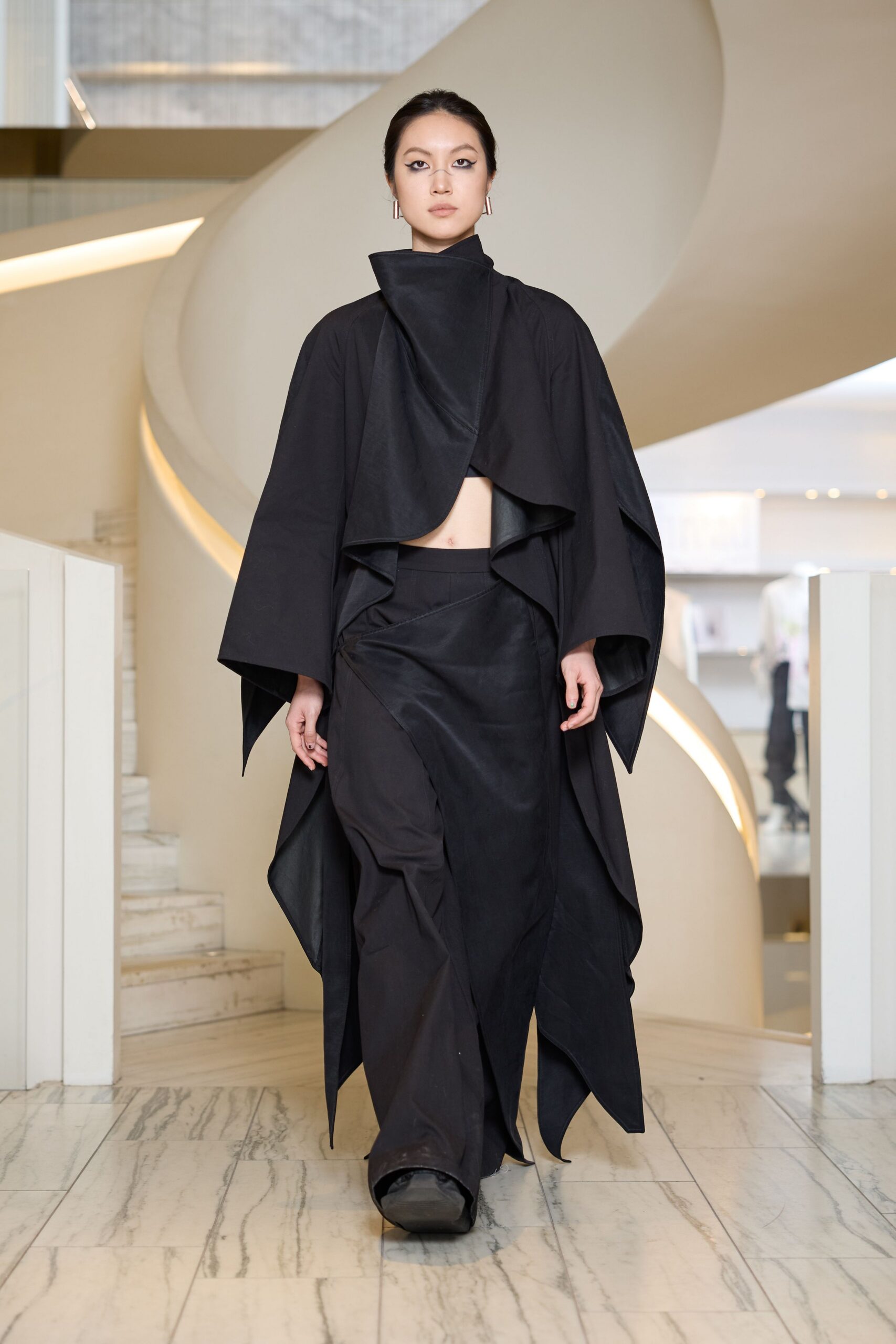 black draped cape and fitted skirt