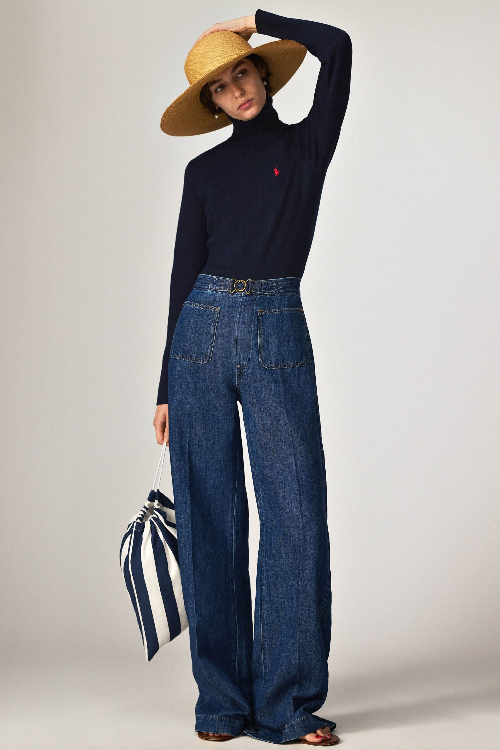navy turtleneck top with wide-leg jeans