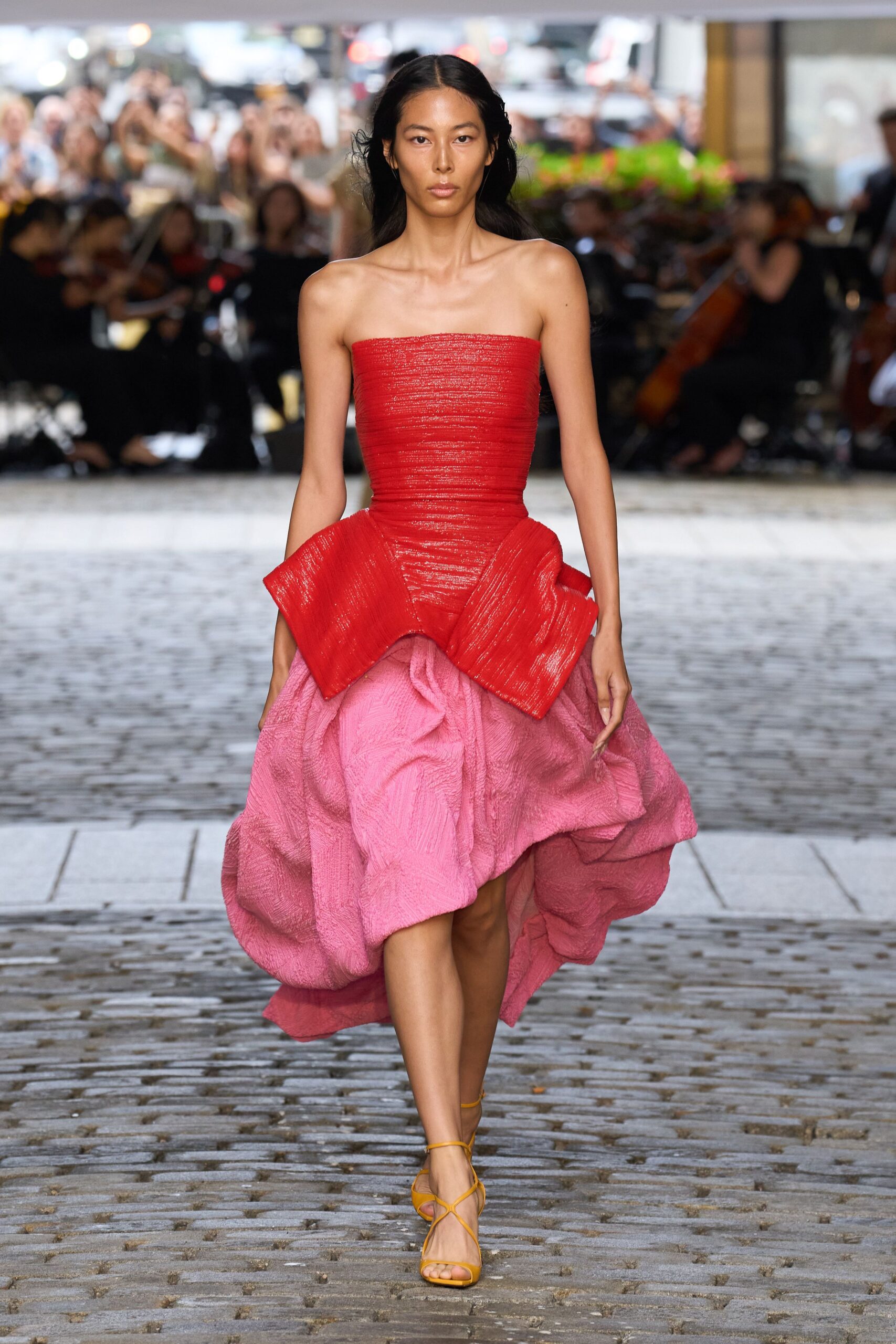 red silk strapless fitted pleated draped flowing dress