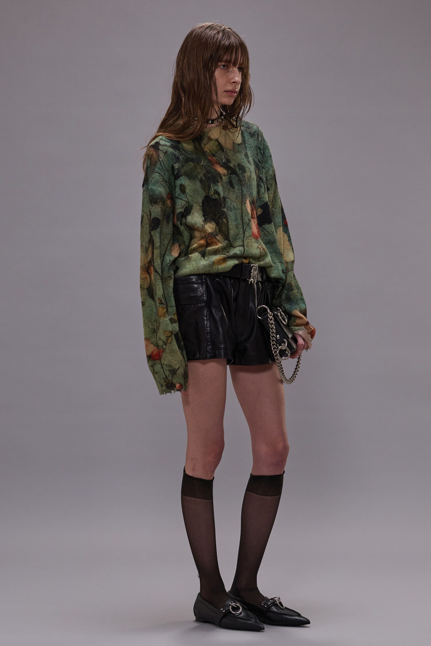 floral green sweater with black leather shorts