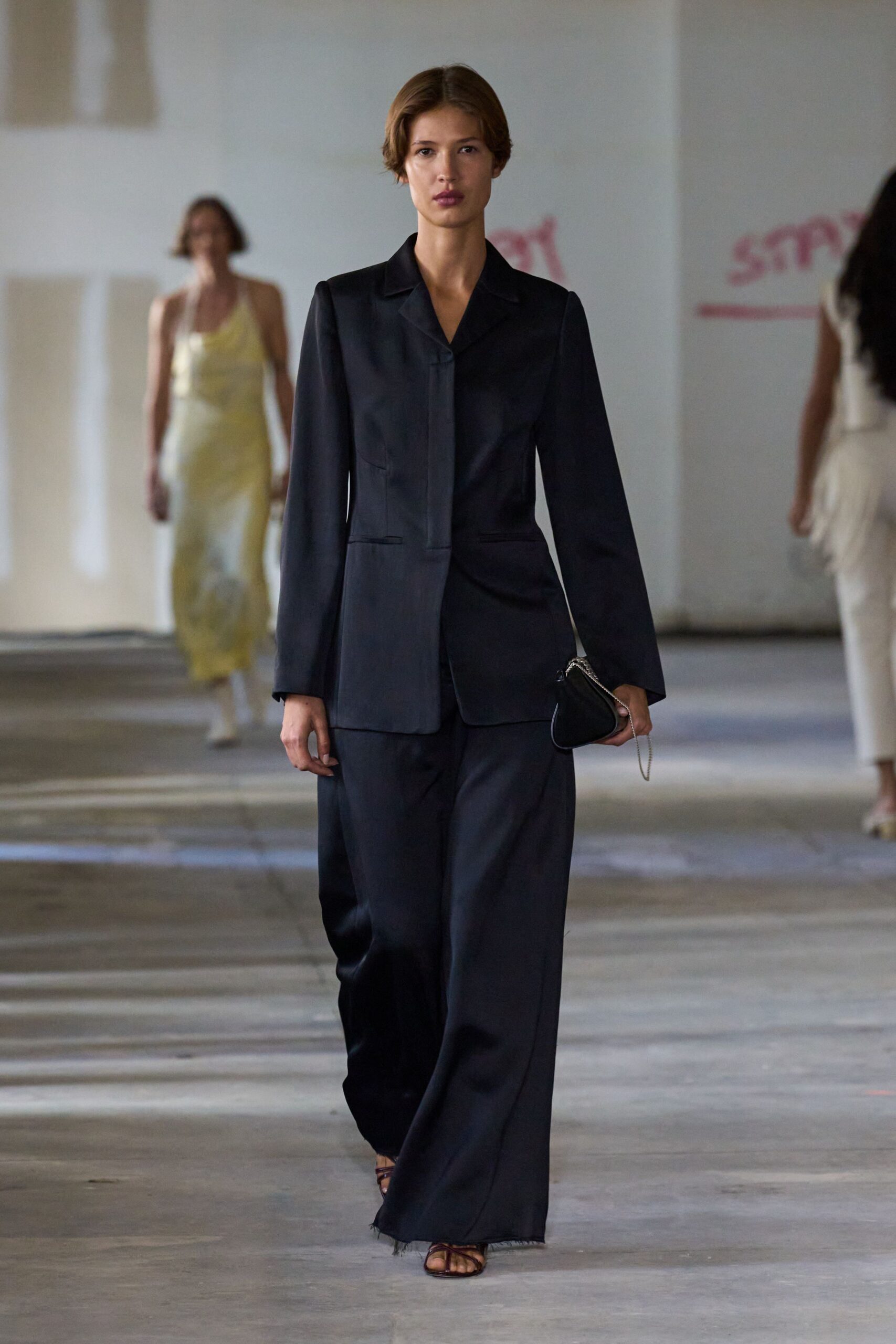 black tailored suit with leather bag