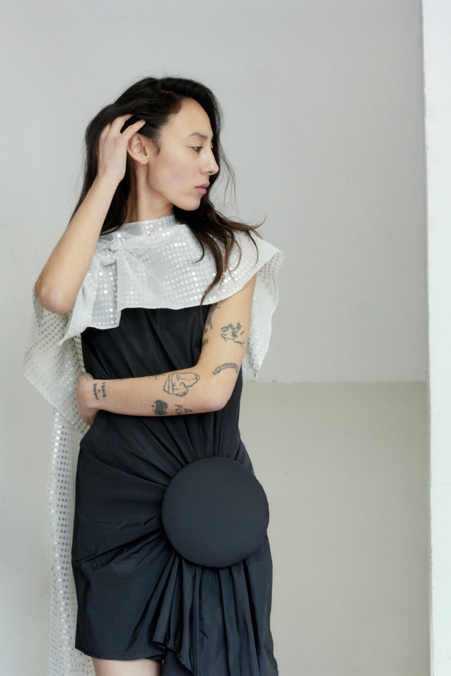 black fitted mini dress with white cape