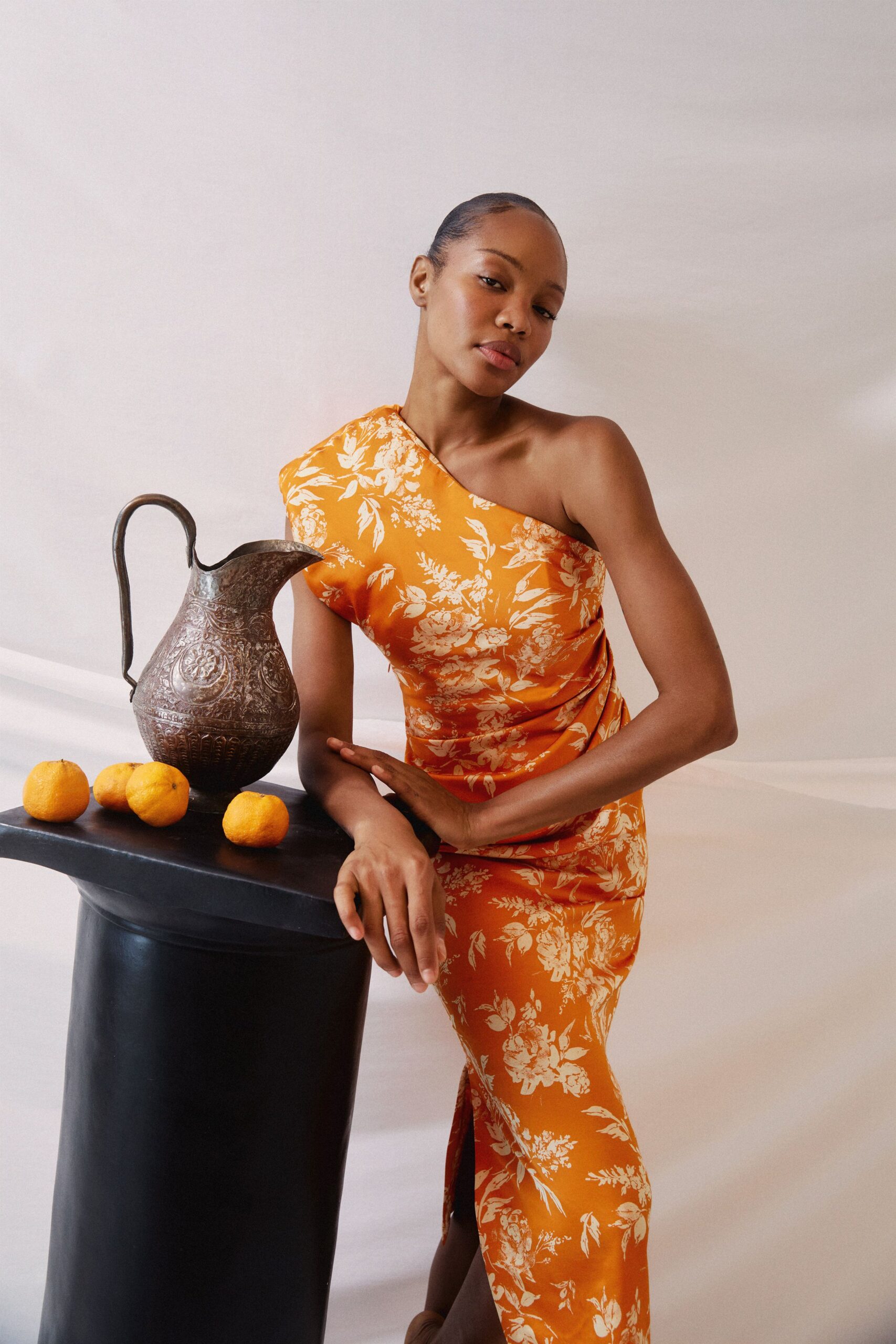 orange silk sleeveless off-shoulder fitted floral draped gown