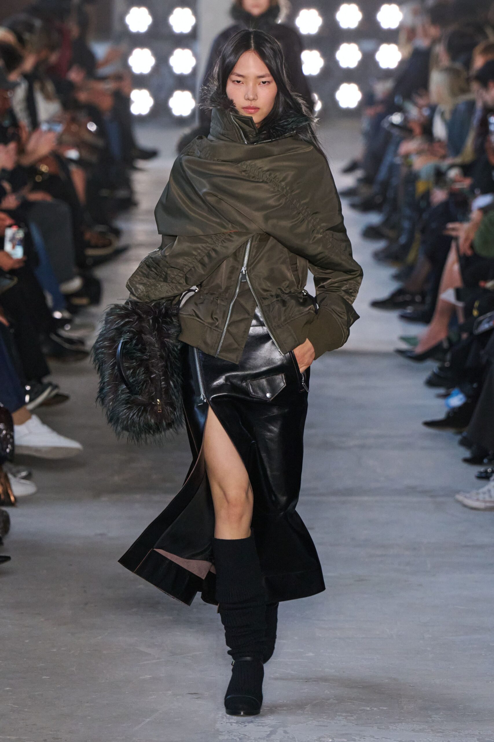 green fitted jacket with black leather skirt