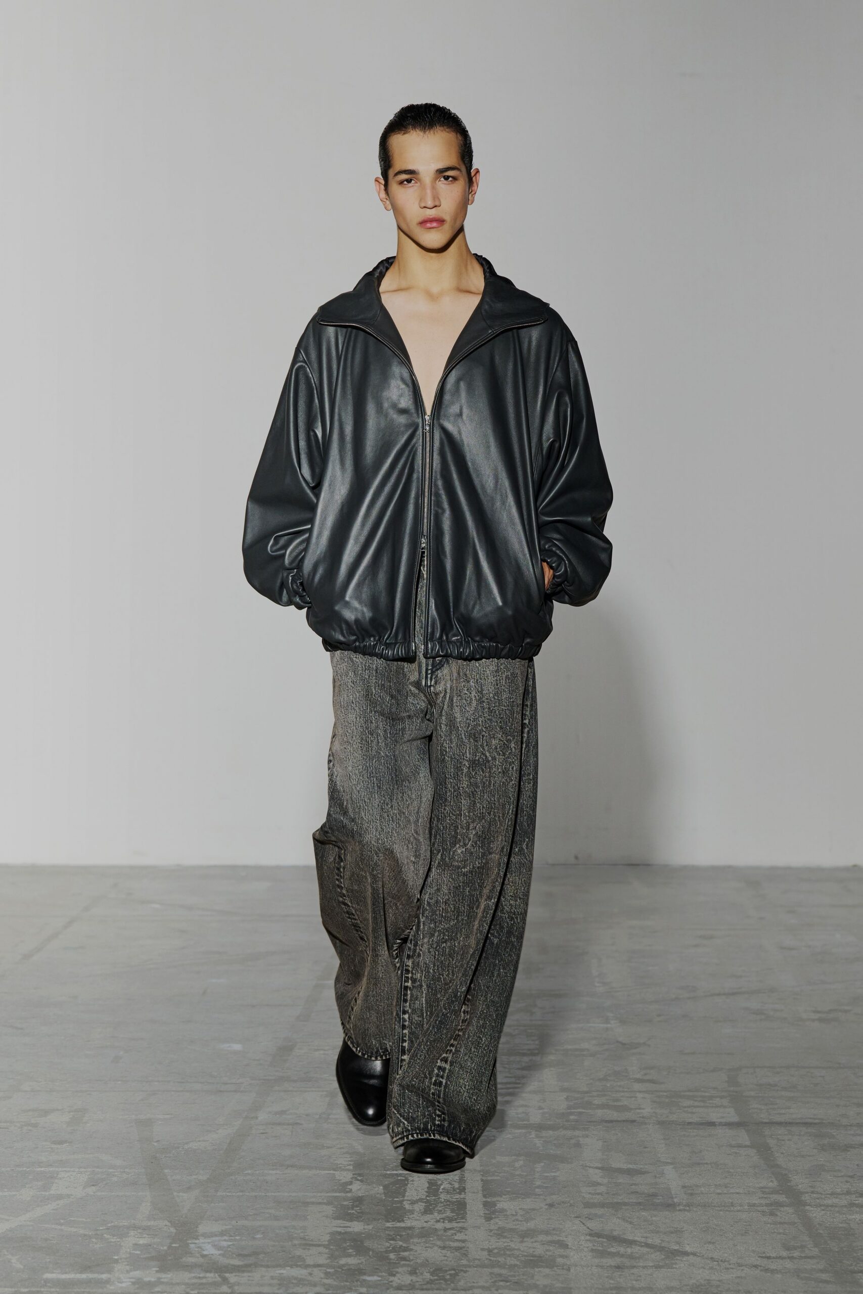 black leather oversized jacket with gray relaxed pants