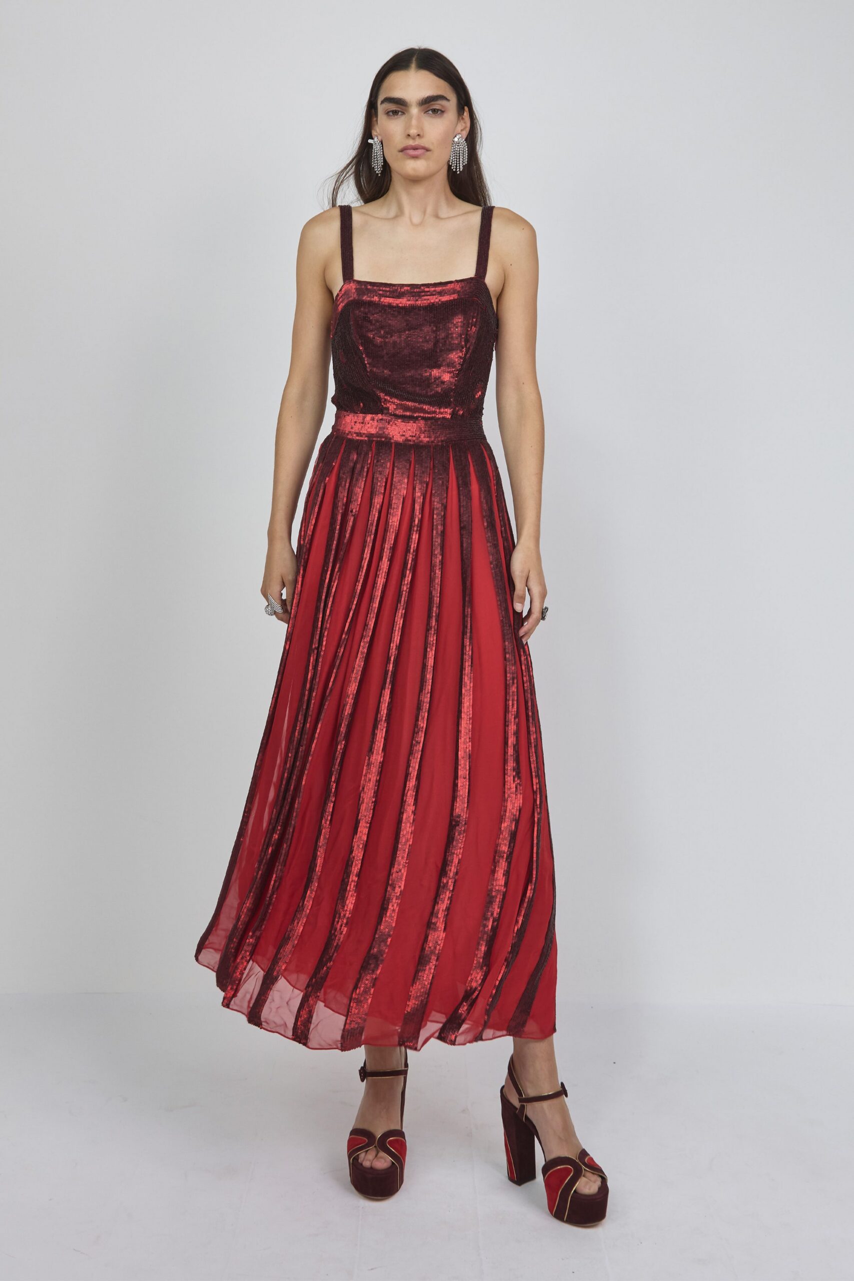 red pleated maxi gown with platform shoes