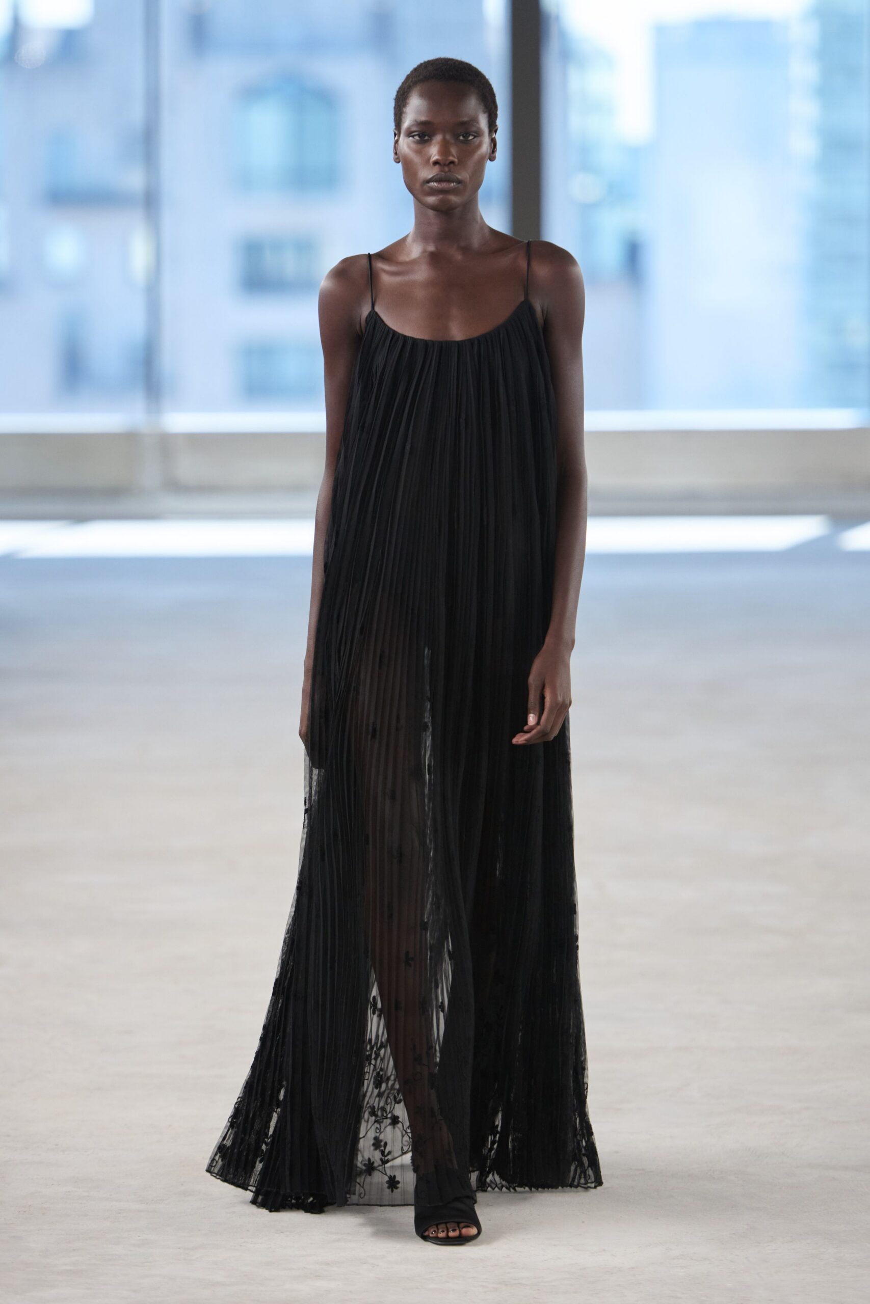 black pleated maxi dress with open-toe shoes