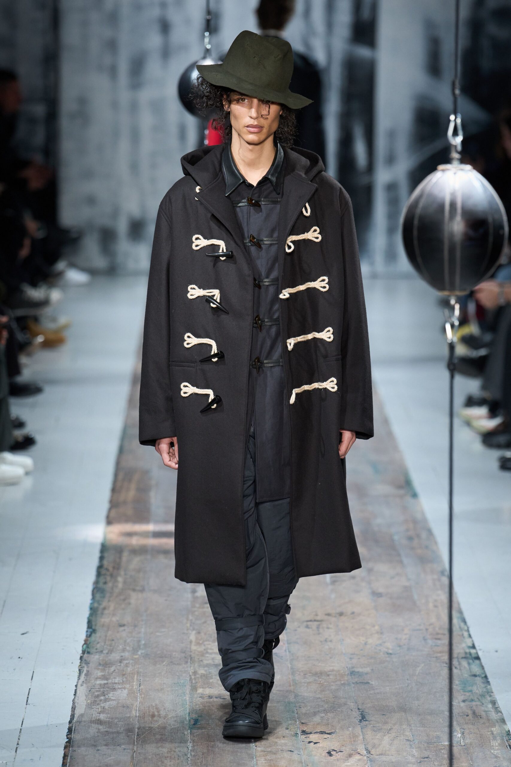 black coat with green hat