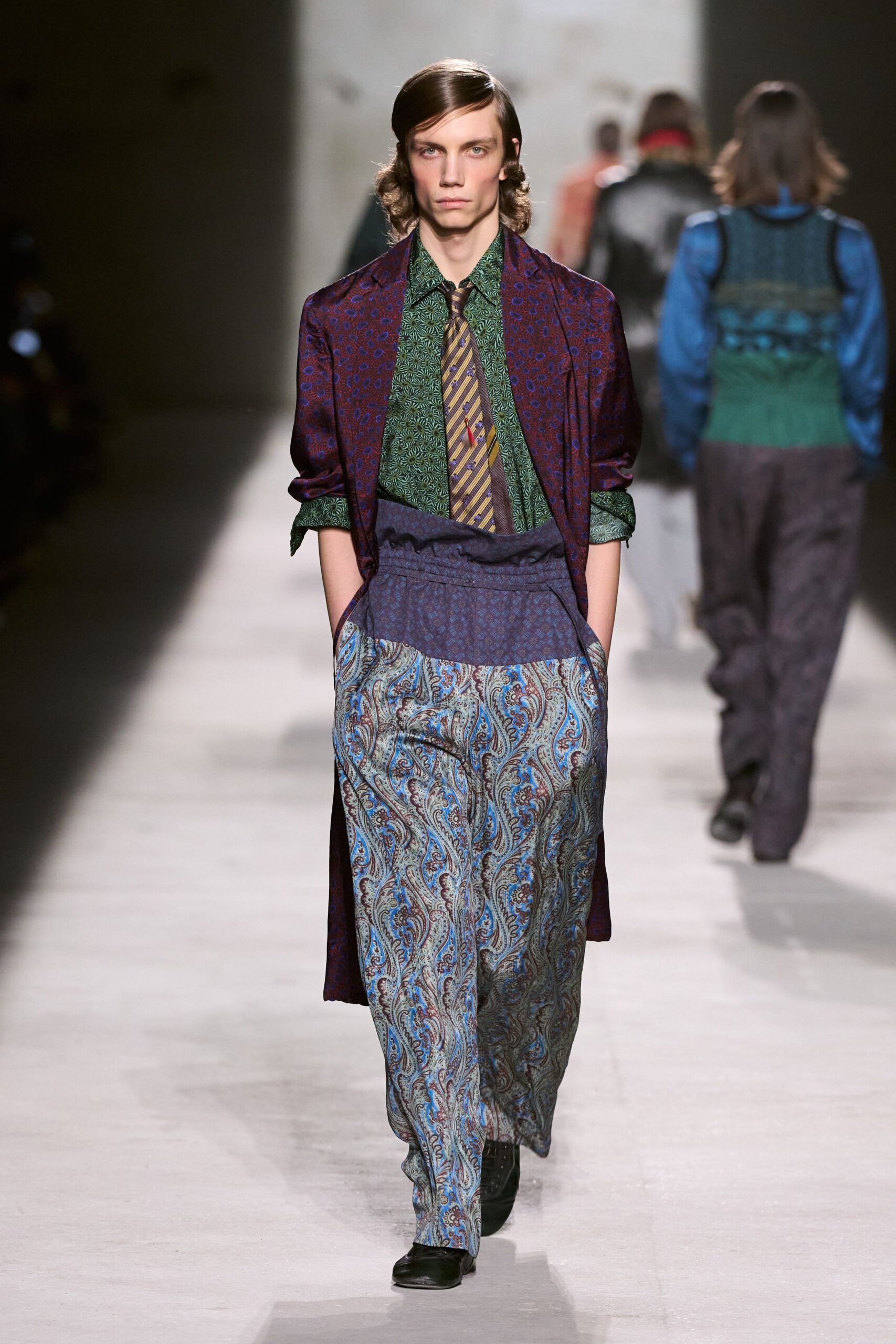 purple coat green shirt patterned pants