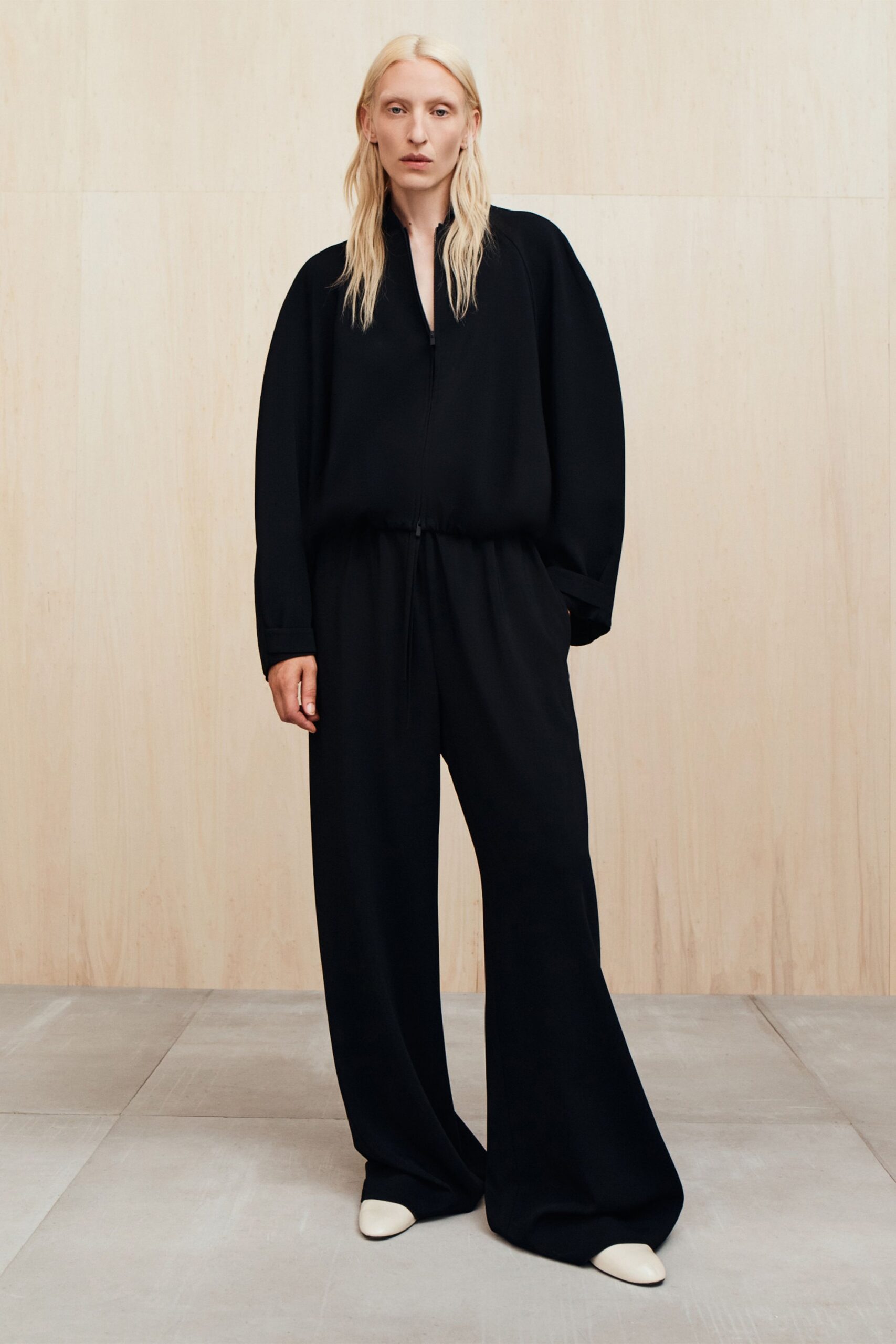 black relaxed jumpsuit with white shoes