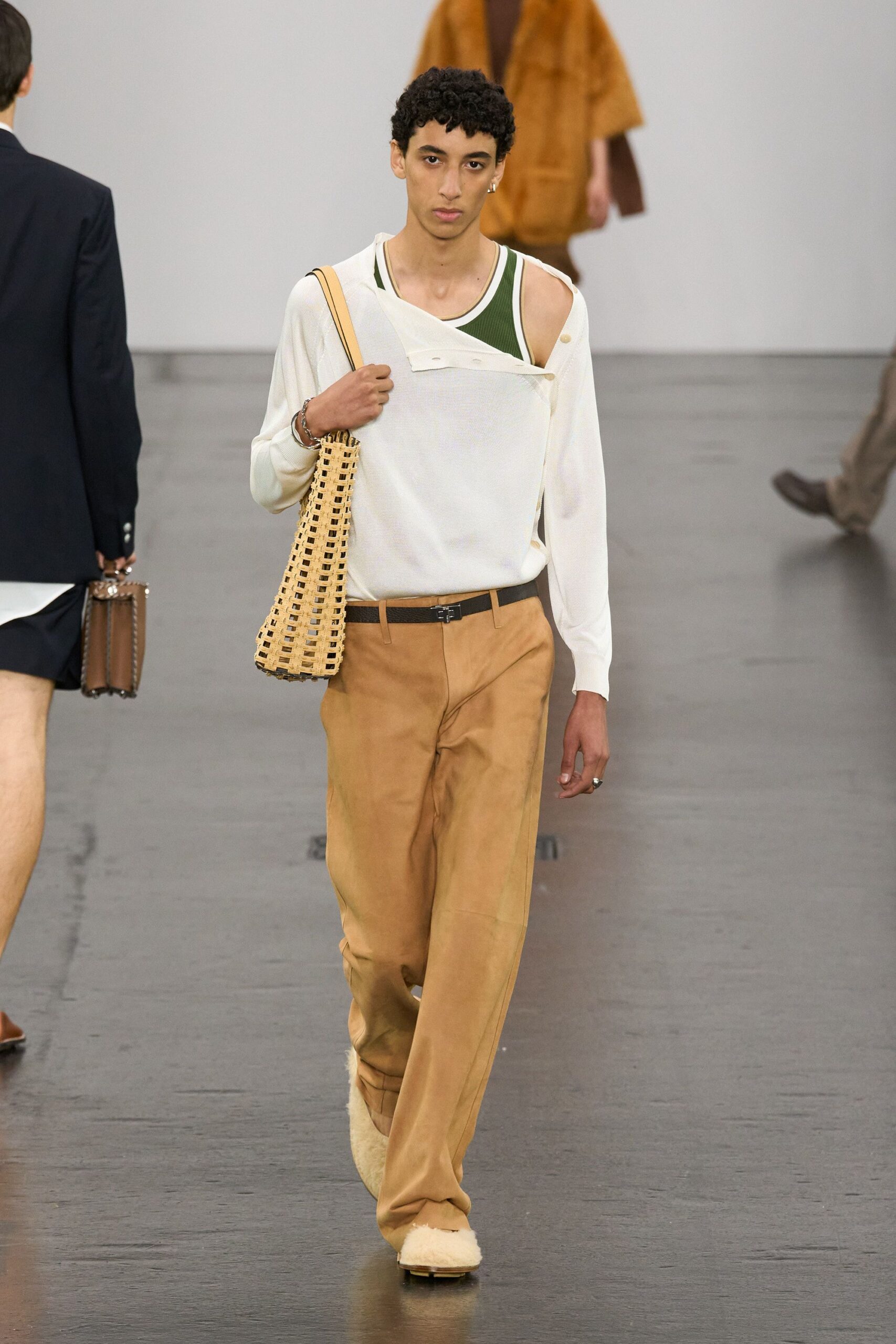 white shirt green tank-top beige pants