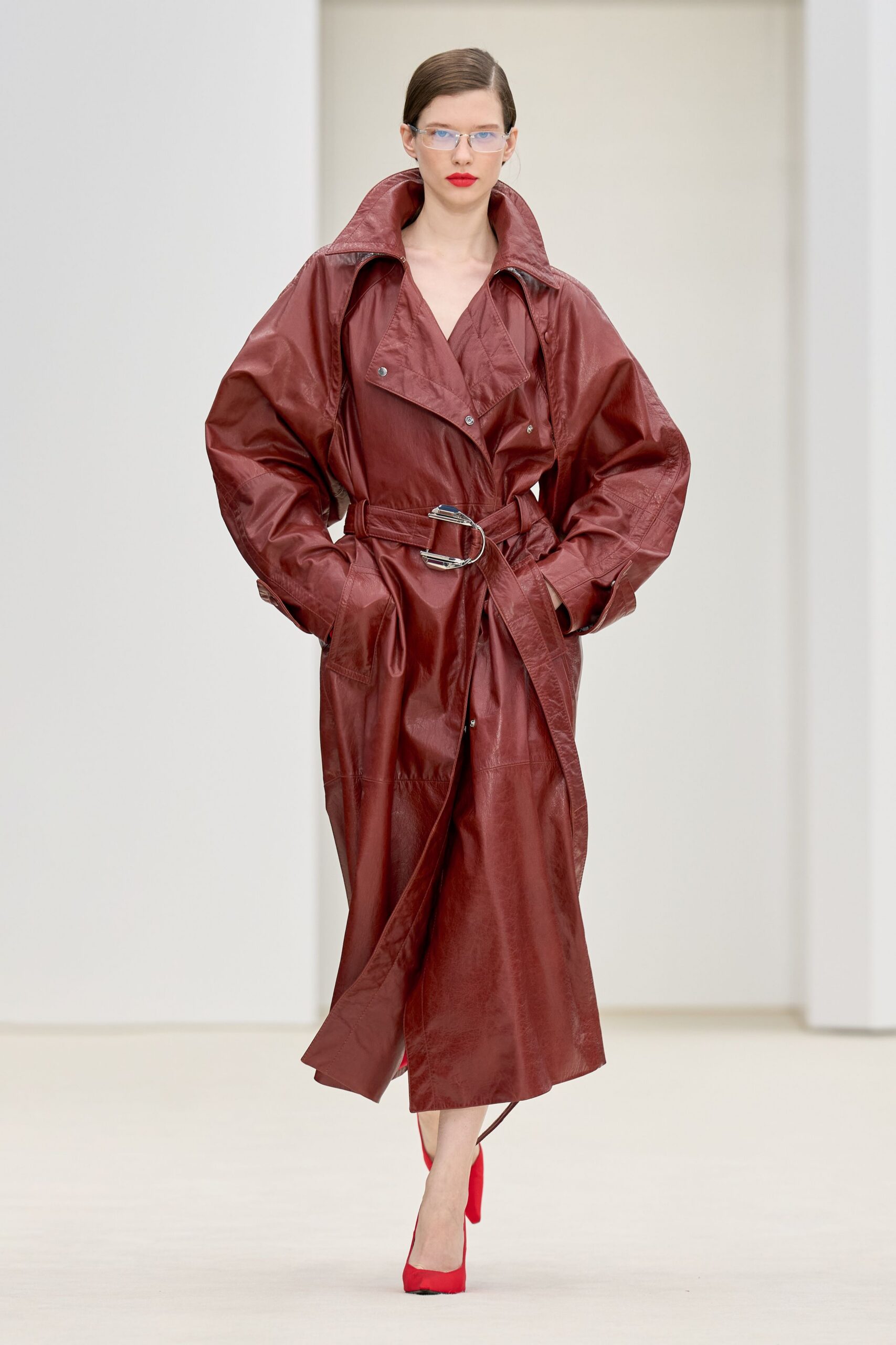 red leather long-sleeve collared oversized belted zippered trench