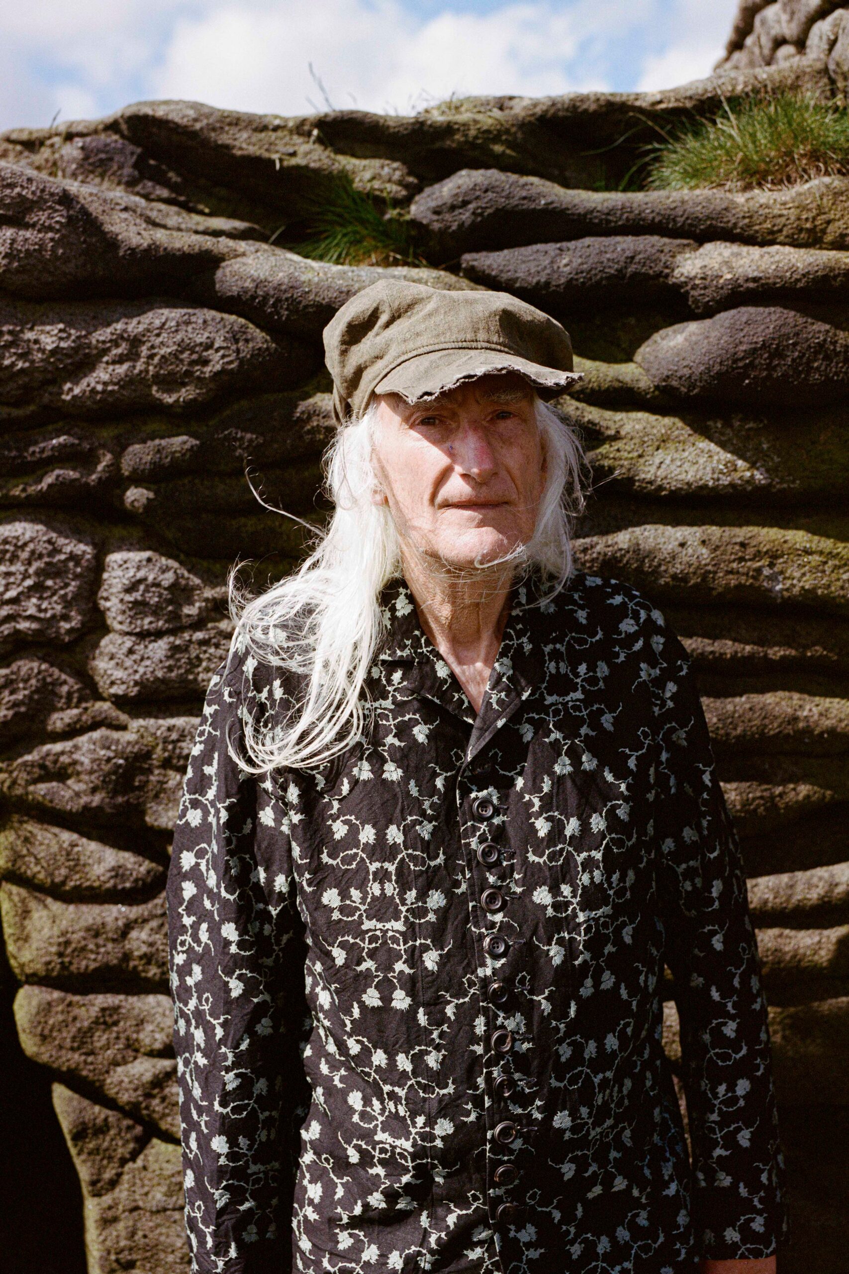 black and white printed shirt with gray hat