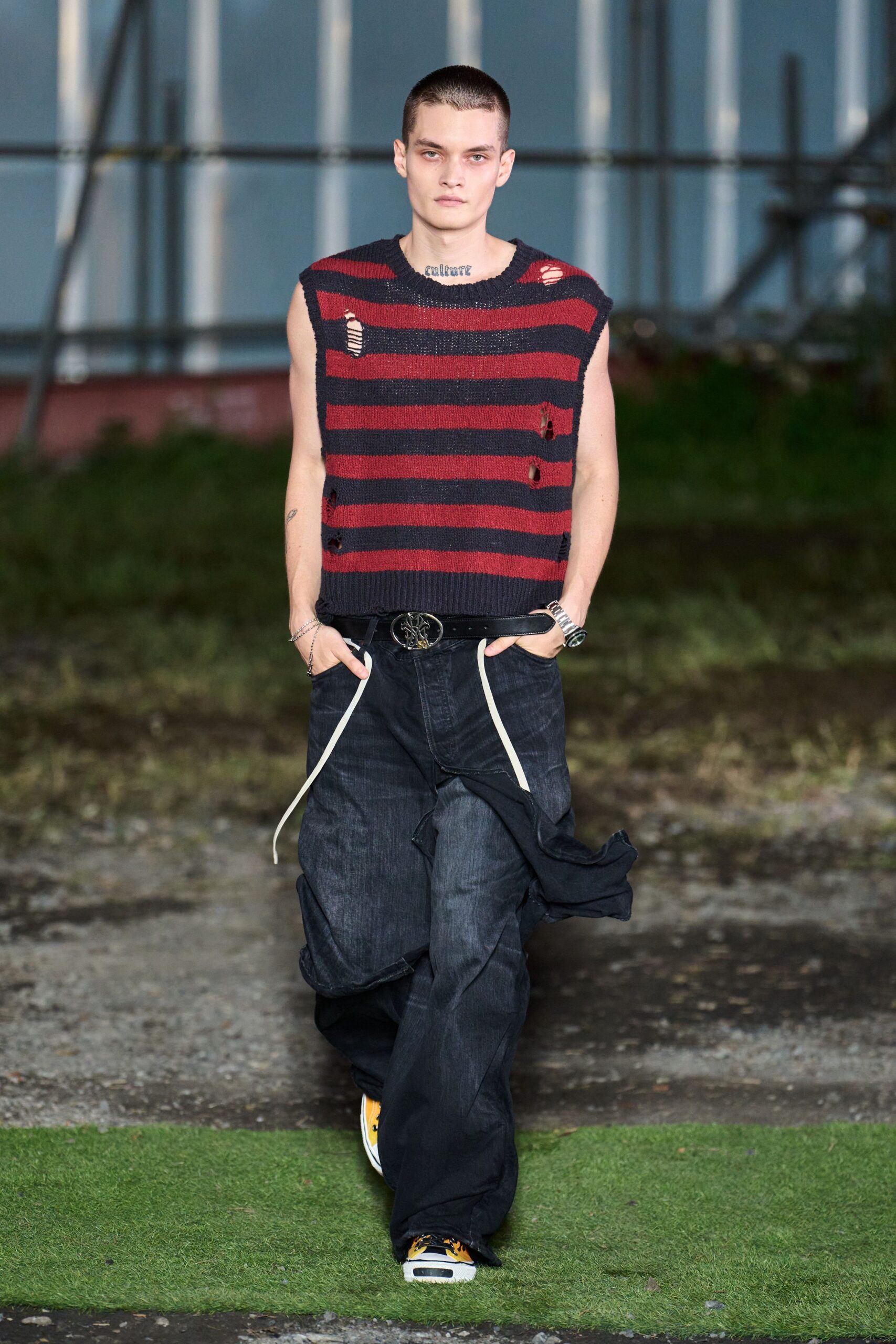 red and blue striped top with black pants
