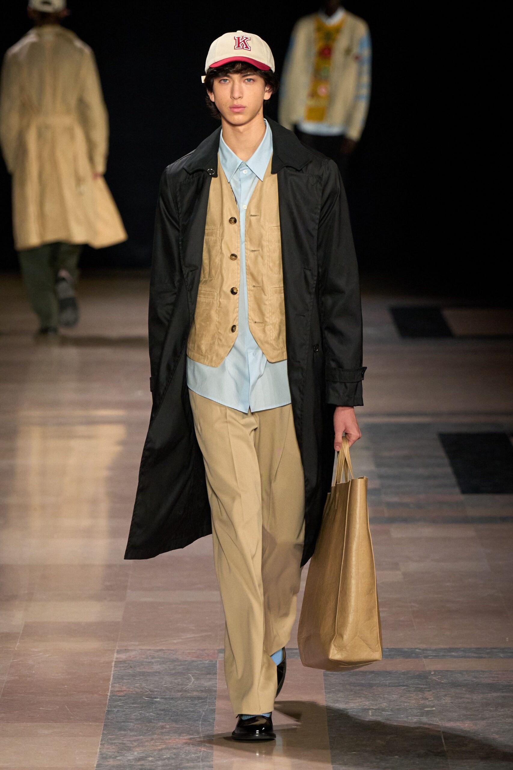 black coat beige vest blue shirt