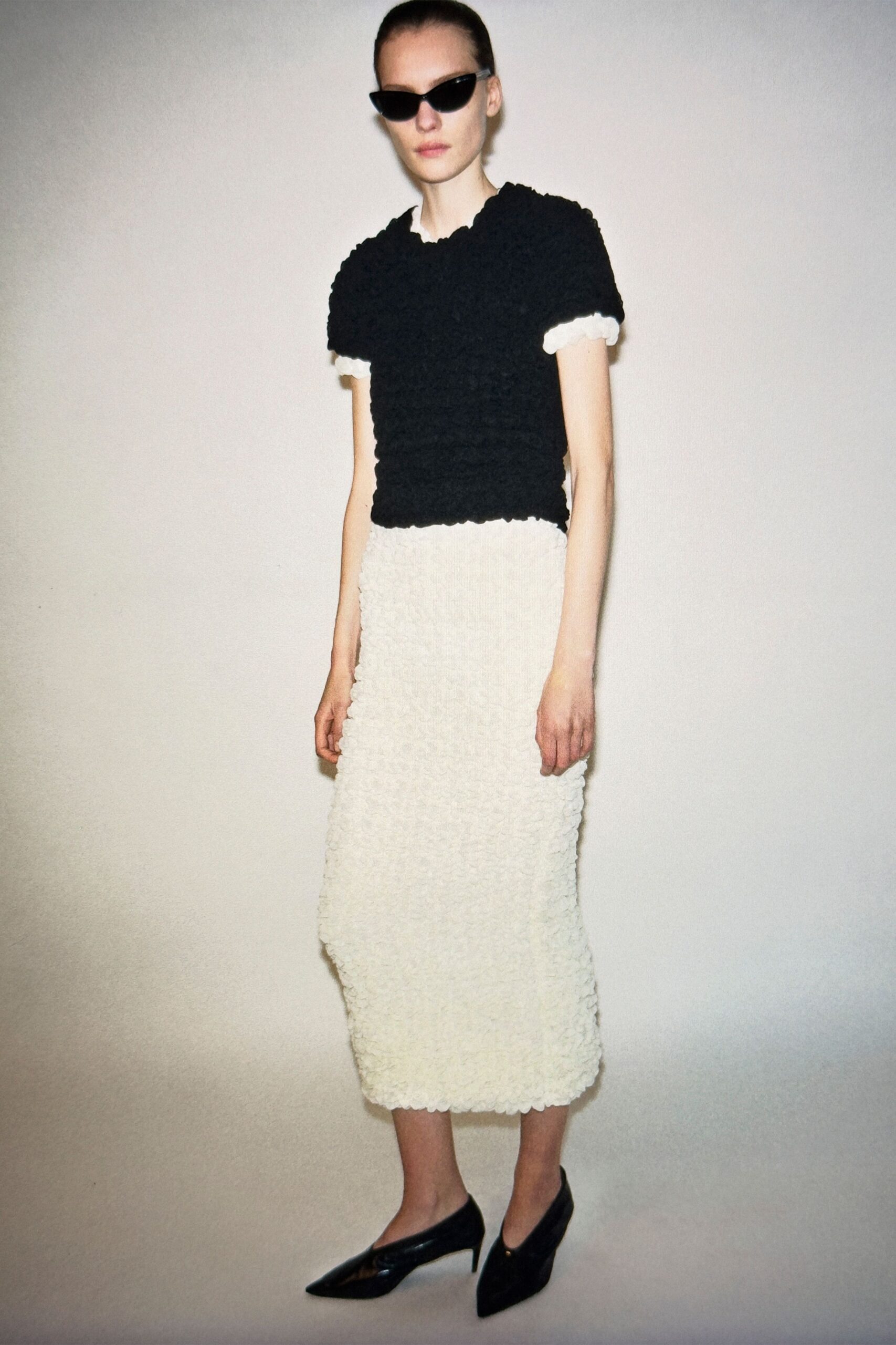 black top white ruffled skirt