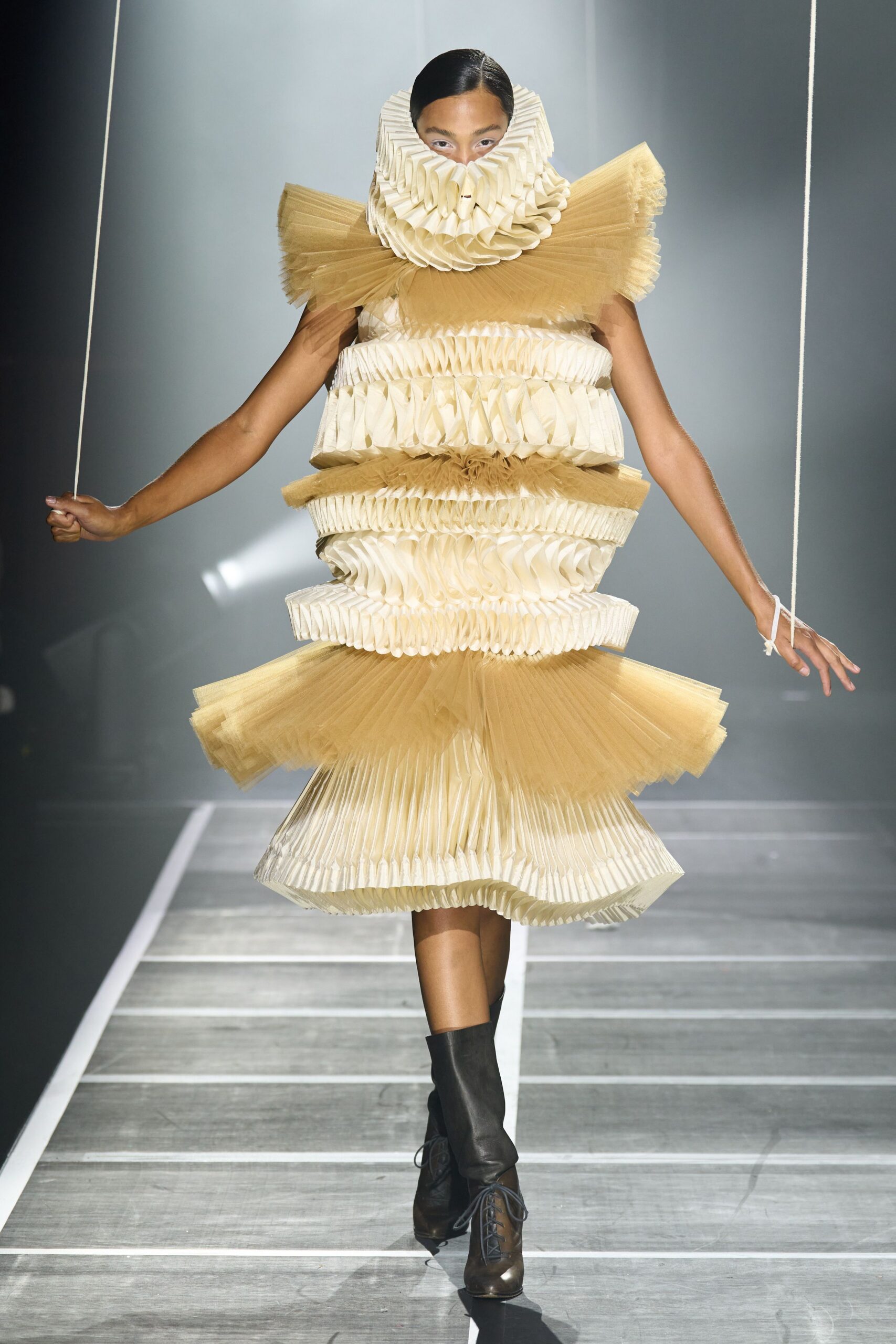 beige pleated midi dress with black boots