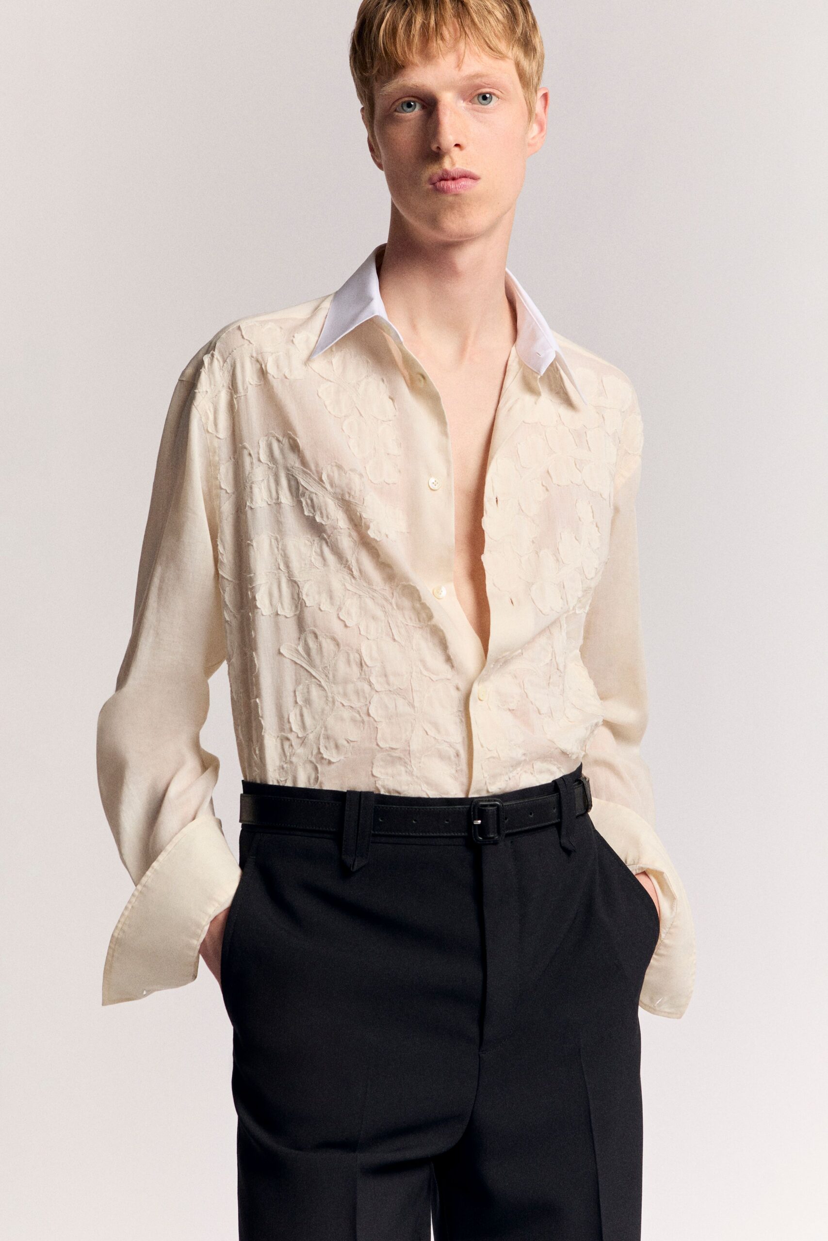 beige embroidered shirt and black tailored pants