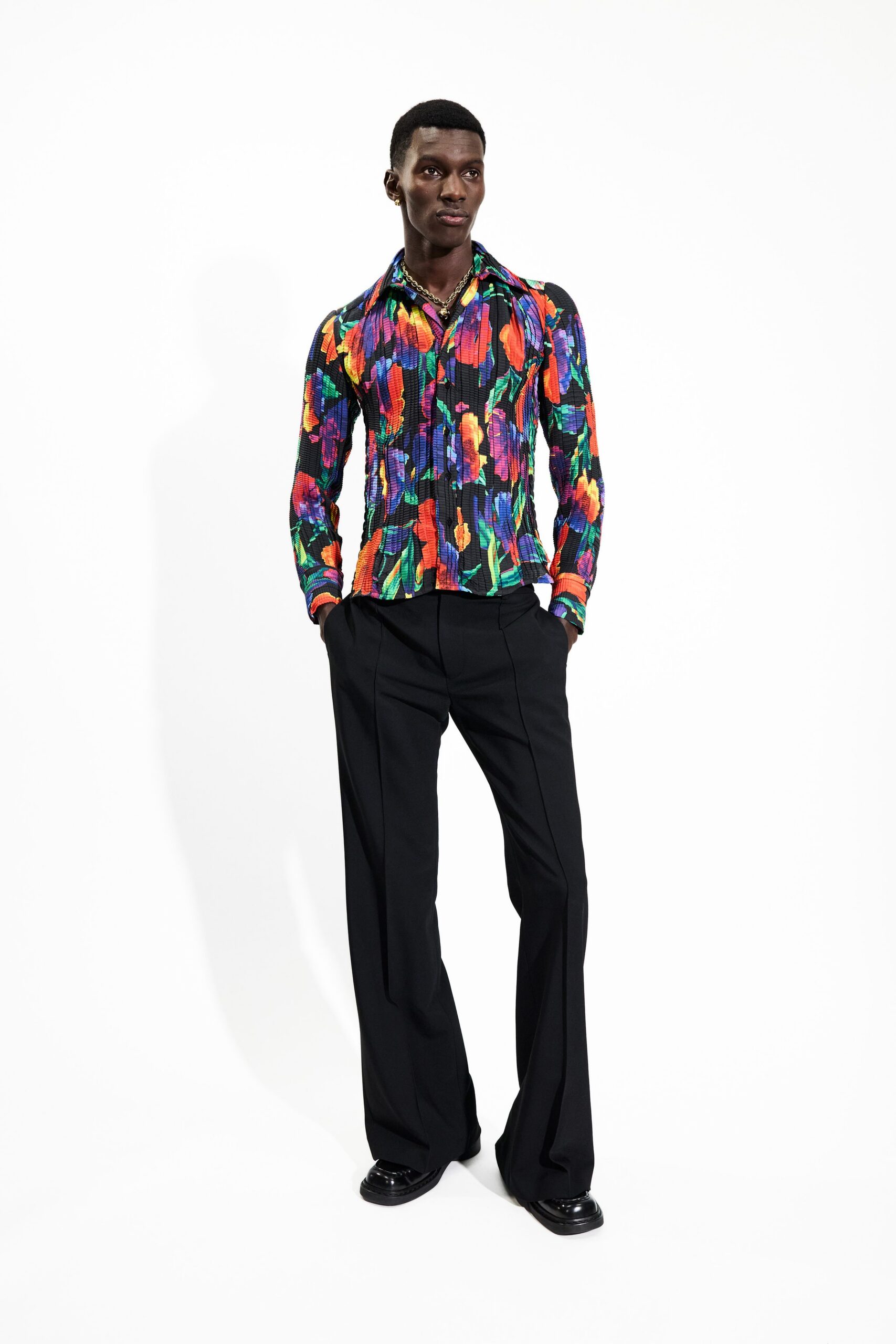 multi-colored fitted shirt with black pants