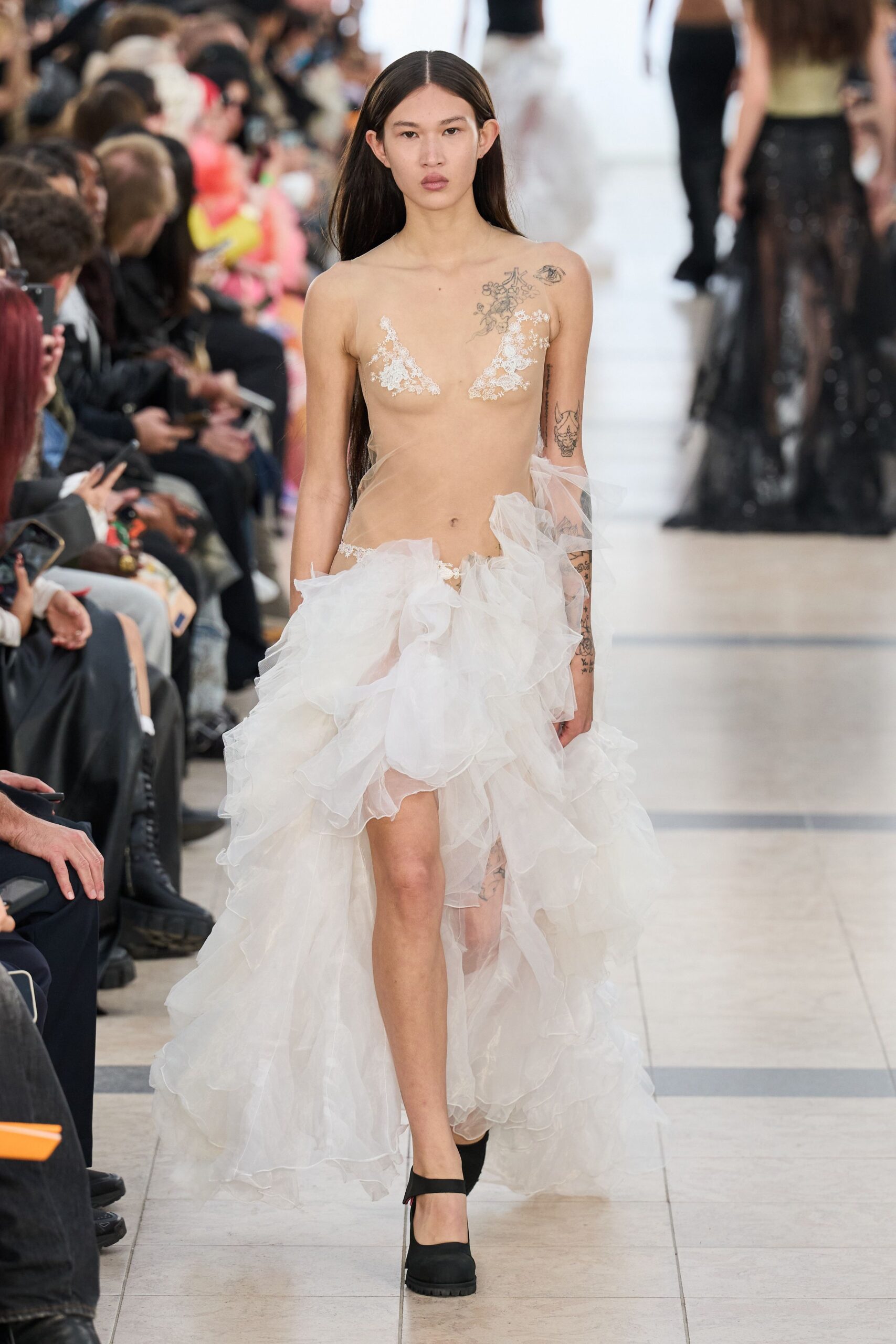 white ruffled gown with black shoes