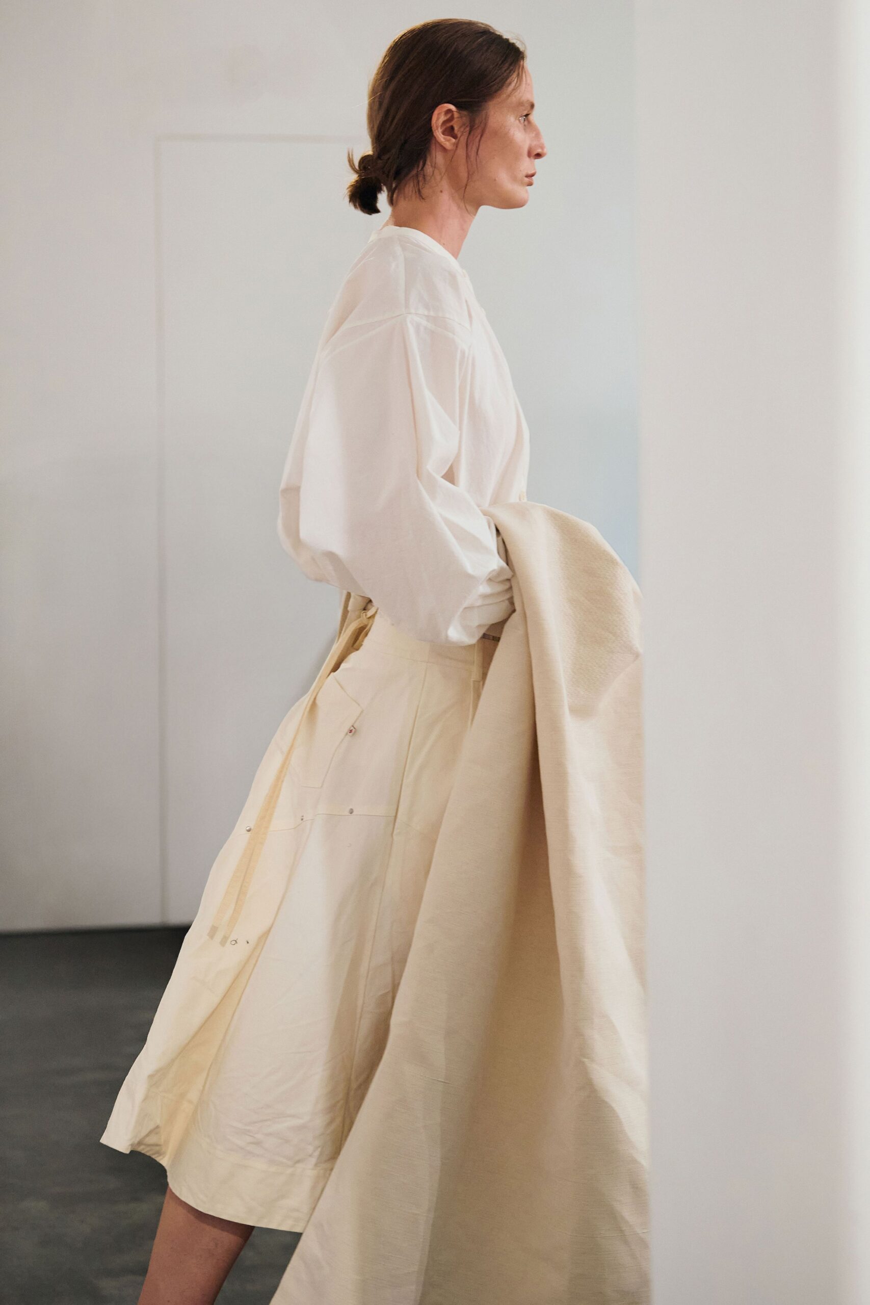 white oversized shirt beige pleated skirt