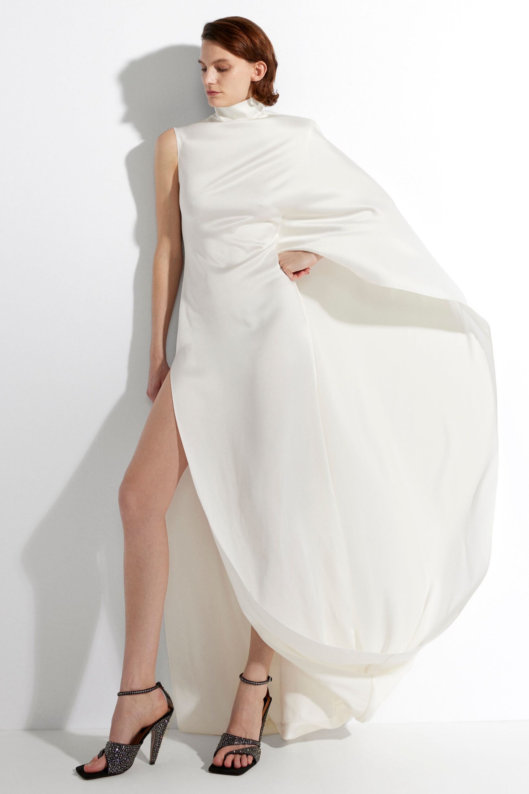 white silk sleeveless high-neck fitted draped flowing gown