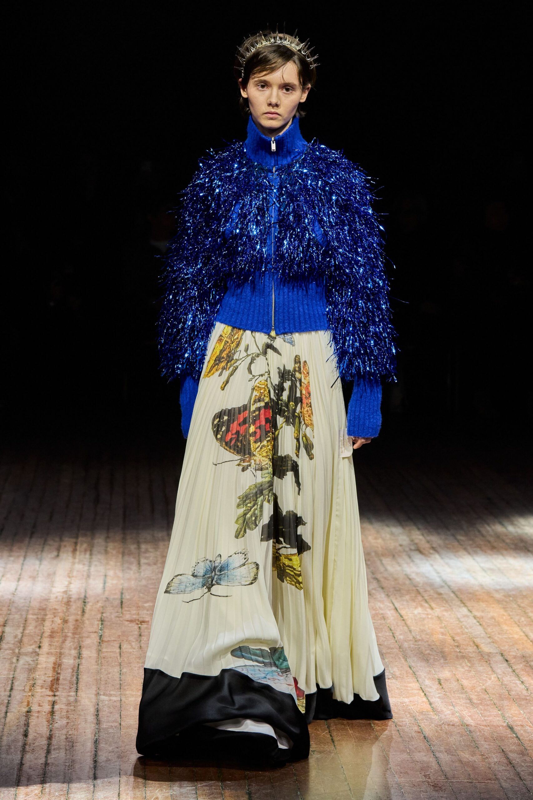 blue fringed sweater and multi-colored dress