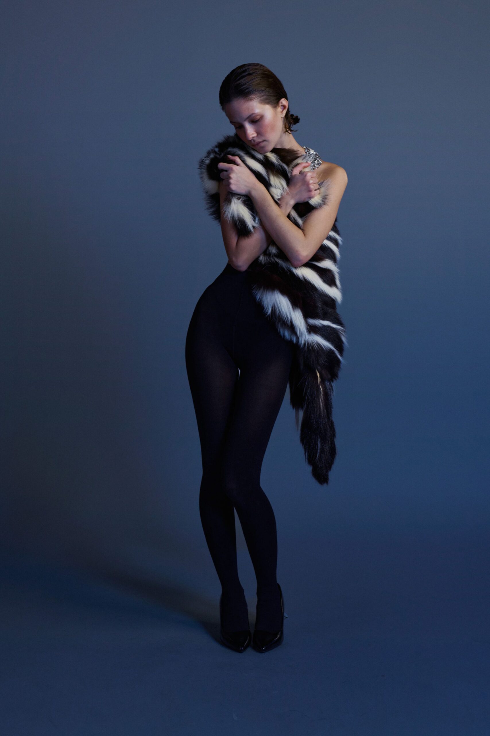 black bodysuit with striped cape